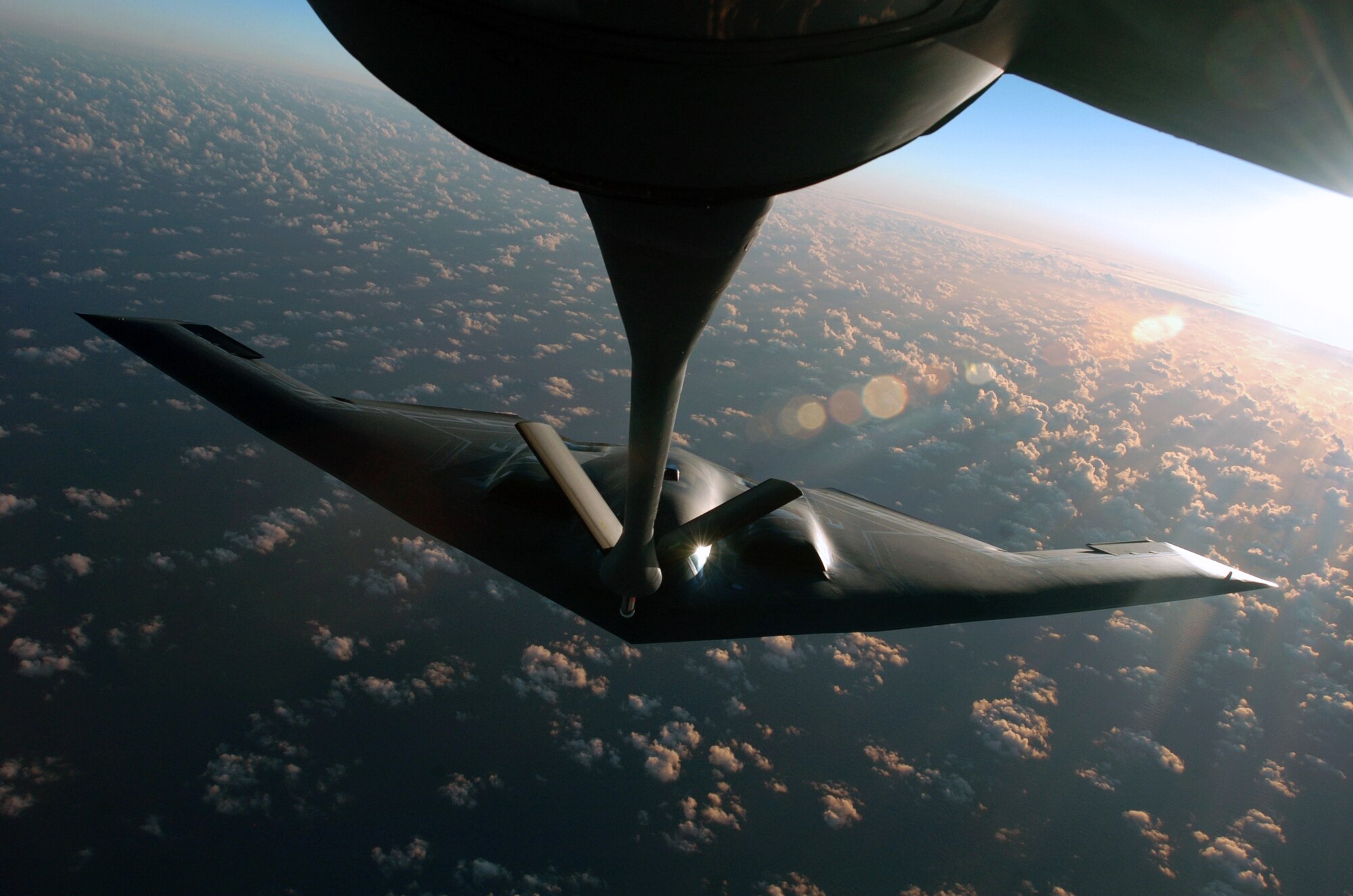 OVER THE PACIFIC OCEAN -- A B-2 Spirit bomber prepares to refuel from a KC-135 Stratotanker during a deployment to Andersen Air Force Base, Guam.  The bomber deployed as part of a rotation that has provided U.S. Pacific Command officials a continuous bomber presence in the Asia-Pacific region, enhancing regional security and the U.S. commitment to the Western Pacific.  The Spirit is from the 509th Bomb Wing at Whiteman AFB, Mo.  The Stratotanker is assigned to the Illinois Air National Guard's 126th Air Refueling Wing at Scott AFB.  (U.S. Air Force photo by Master Sgt. Val Gempis)