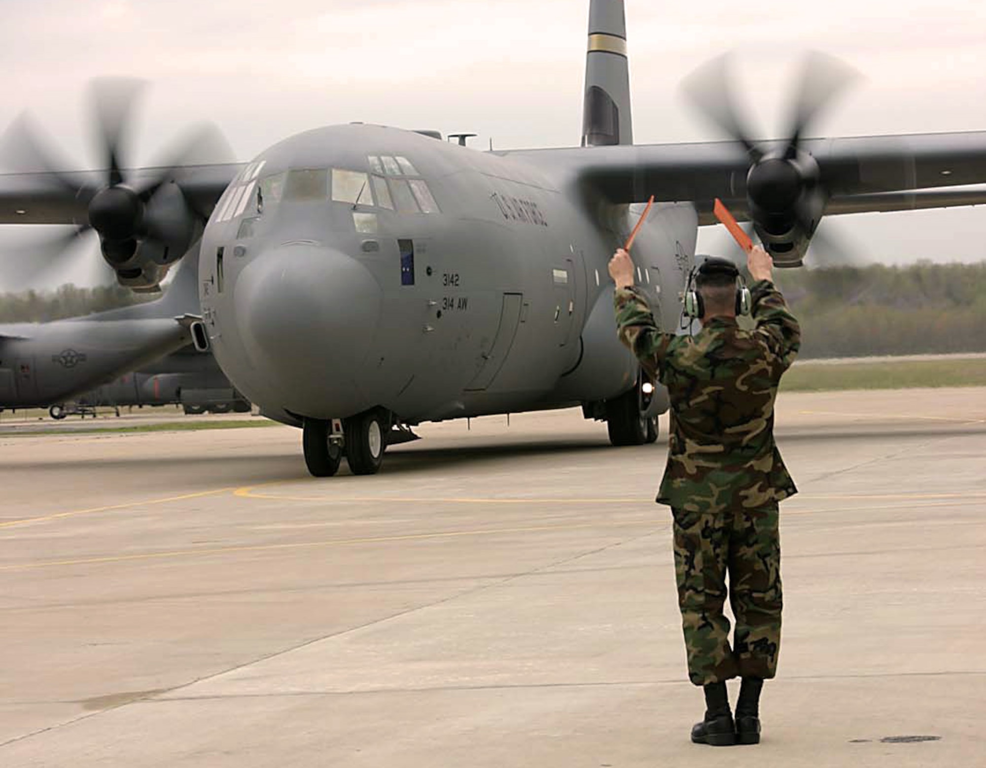 LITTLE ROCK AIR FORCE BASE, Ark. -- Tech. Sgt. Jonathan Rebidue marshals in the Air Force's second active-duty J-model C-130 Hercules here April 5.  Sergeant Rebidue is a C-130 dedicated crew chief.  (U.S. Air Force photo by Airman 1st Class Tim Bazar)