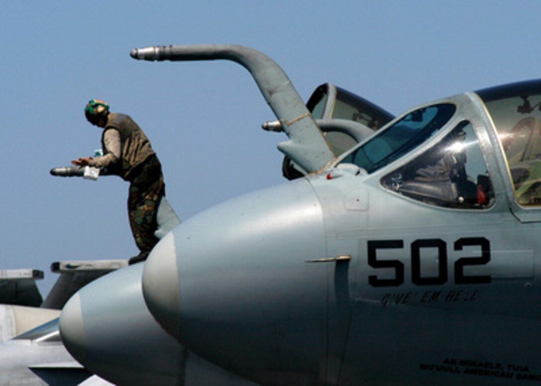 A sailor assigned to the Electronic Attack Squadron 130 cleans the aerial fueling probe of an EA-6B Prowler prior to flight operations on the flight deck of the USS Harry S. Truman (CVN 75) while underway in the Persian Gulf on March 17, 2005. The Truman Strike Group and Carrier Air Wing 3 are conducting close air support, intelligence, surveillance, and reconnaissance missions over Iraq. 