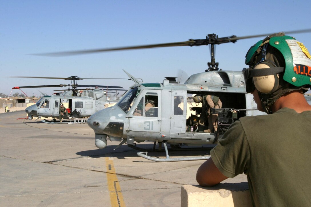Cpl. Michael J. Allerite of Marine Medium Helicopter Squadron 165(REIN), 15th Marine Expeditionary Unit (SOC), watches as a UH-1N Huey as it takes off on a mission. The 15th MEU (SOC) is wrapping up one month of security and stabilization operations in the Greater Baghdad area.