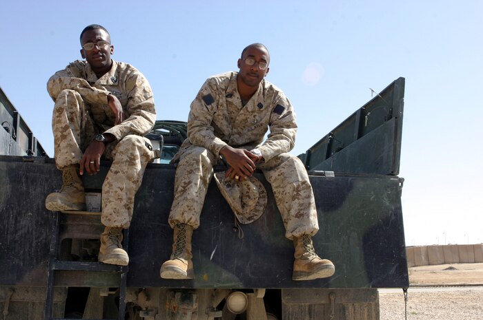 AL ASAD, Iraq – Petty Officer 2nd Class Sean Hurley (left) and Seaman Albert Hendrick Jr., both with Surgical Company, Combat Logistics Battalion 2, 2d Force Service Support Group (Forward), made a startling discovery two days before they deployed to Iraq earlier this year: they are brothers. (Photo by Cpl. John E. Lawson Jr.)