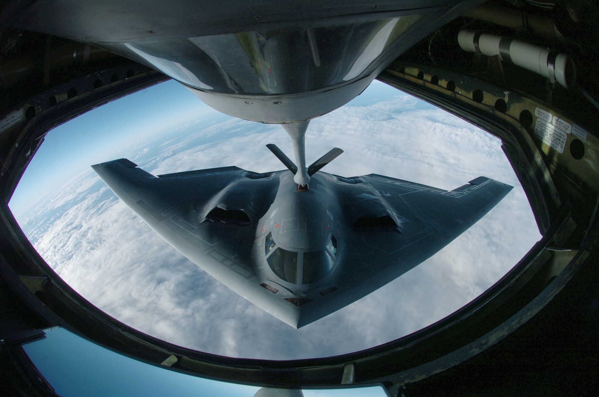 OVER THE PACIFIC OCEAN -- A B-2 Spirit bomber refuels from a KC-135 Stratotanker here during a deployment to Andersen Air Force Base, Guam.  The bomber deployed as part of a rotation that has provided U.S. Pacific Command officials a continuous bomber presence in the Asia-Pacific region, enhancing regional security and the U.S. commitment to the Western Pacific.  The Spirit is from the 509th Bomb Wing at Whiteman AFB, Mo.  The Stratotanker is assigned to the Illinois Air National Guard's 126th Air Refueling Wing at Scott AFB.  (U.S. Air Force photo by Master Sgt. Val Gempis)