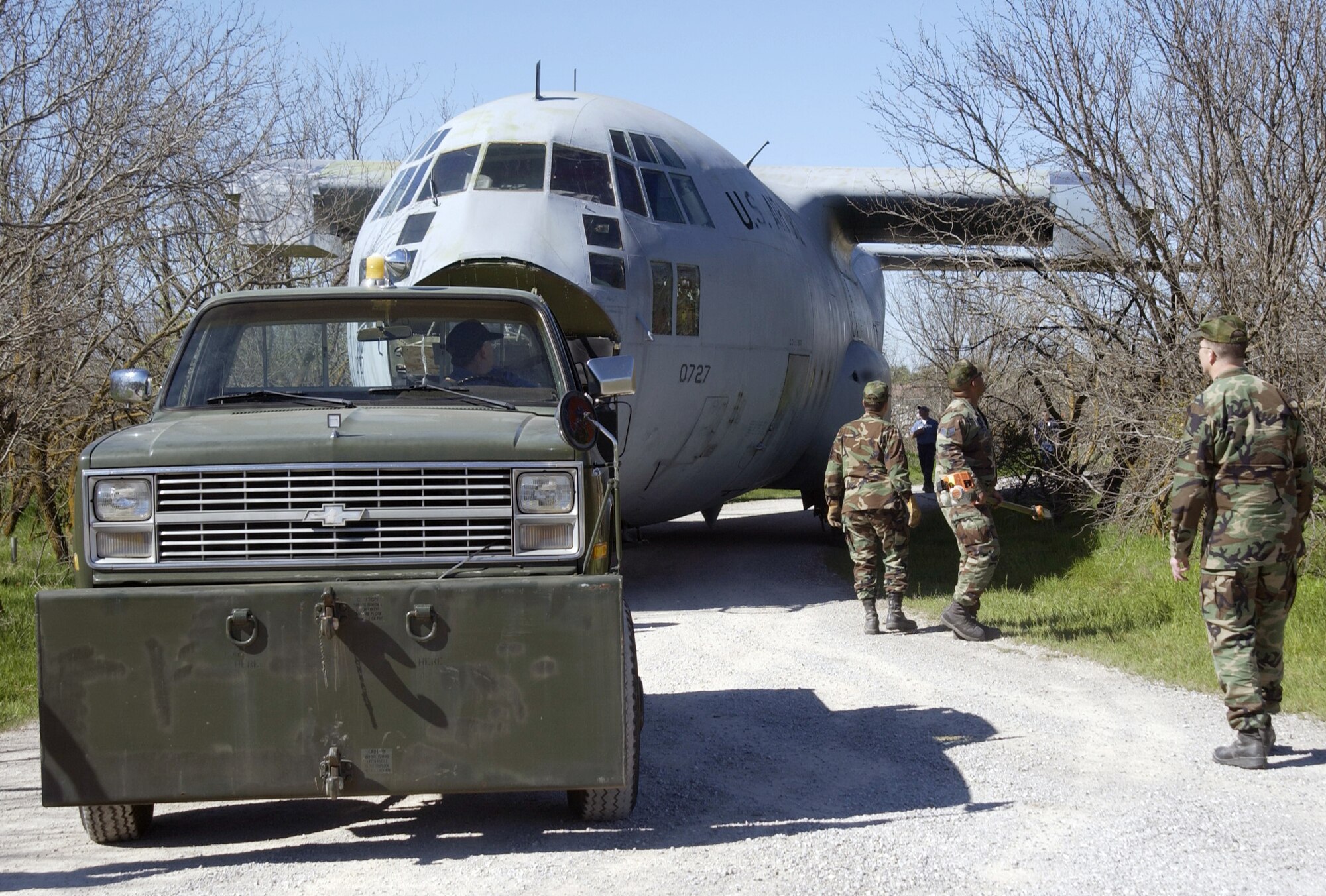 SHEPPARD AIR FORCE BASE, Texas -- Winding roads and low-hanging limbs were a few of the obstacles crews overcame April 2 when they towed a C-130 Hercules to the 381st Training Squadron's medical readiness training site.  The aircraft became the newest piece of training equipment for medics scheduled to deploy an aeromedical evacuation assignment. (U.S. Air Force photo by Sandy Wassenmiller)