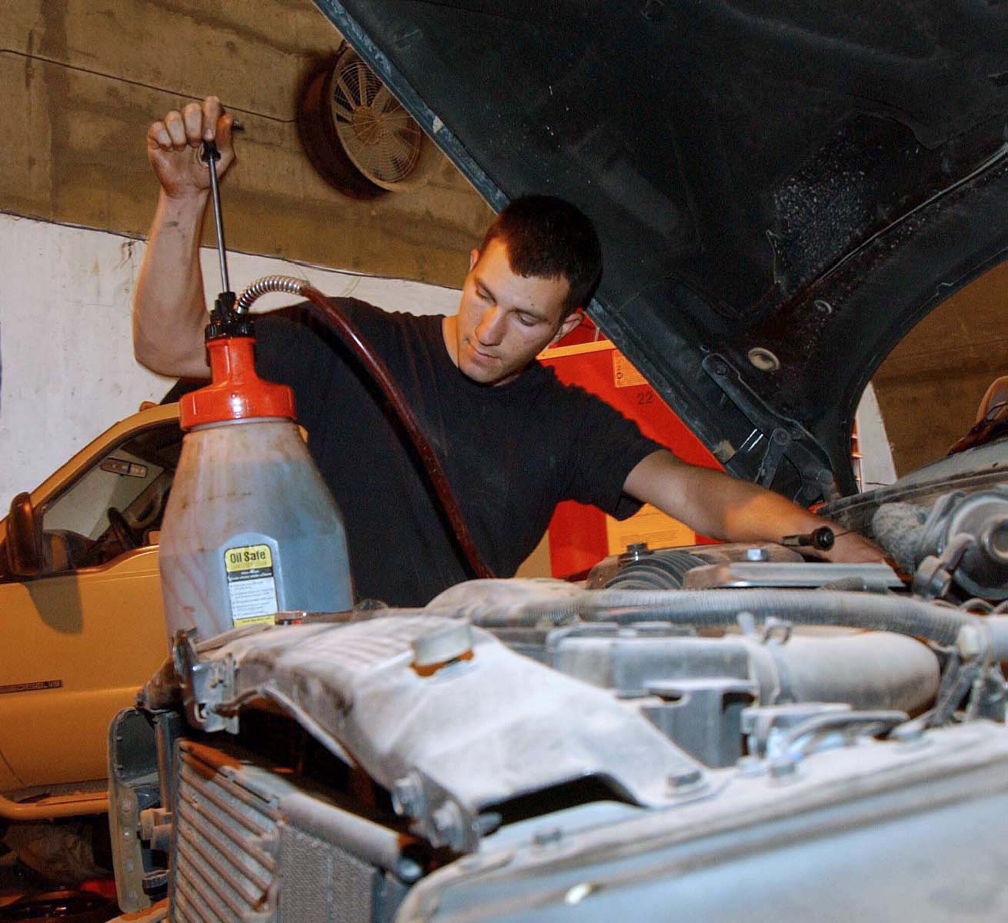 BALAD AIR BASE, Iraq -- Senior Airman William Meredith tops off a flightline truck with transmission fluid.  He is a mechanic with the 332nd Expeditionary Logistics Readiness Squadron here.  (U.S. Air Force photo by Master Sgt. Jim Randall)                     