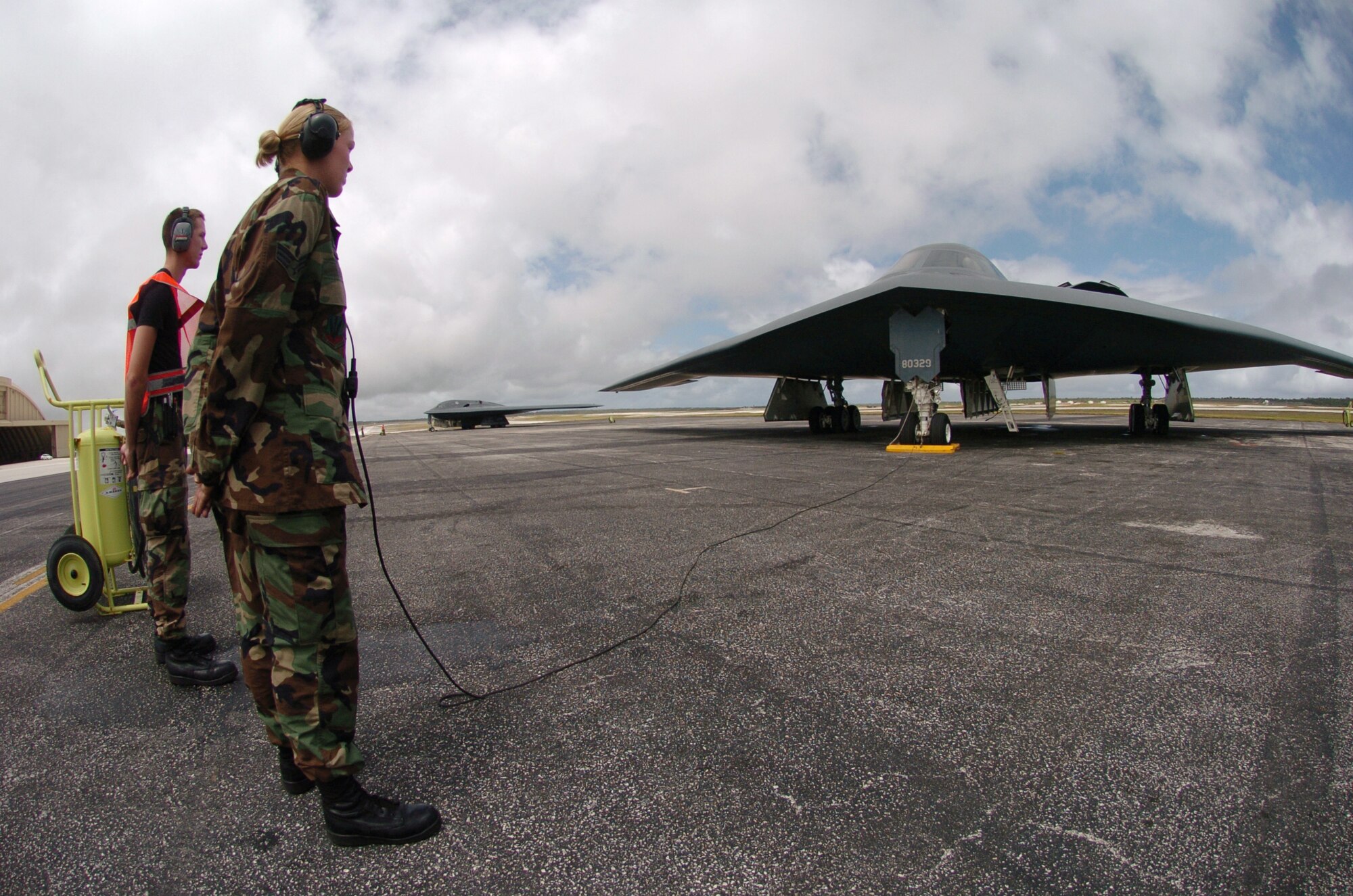 ANDERSEN AIR FORCE BASE, Guam -- Senior Airman Mindy High (foreground) and Airman 1st Class Dustin Spring prepare to launch a B-2 Spirit bomber during a mission here.  The B-2s deployed here Feb. 25 to provide U.S. Pacific Command officials a continuous bomber presence in the Asia-Pacific region, enhancing regional security and the U.S. commitment to the Western Pacific.  Bomber aircraft have had an ongoing presence on the island since February 2004.  The Airmen are crew chiefs from the 509th Bomb Wing at Whiteman Air Force Base, Mo.  (U.S. Air Force photo by Master Sgt. Val Gempis)