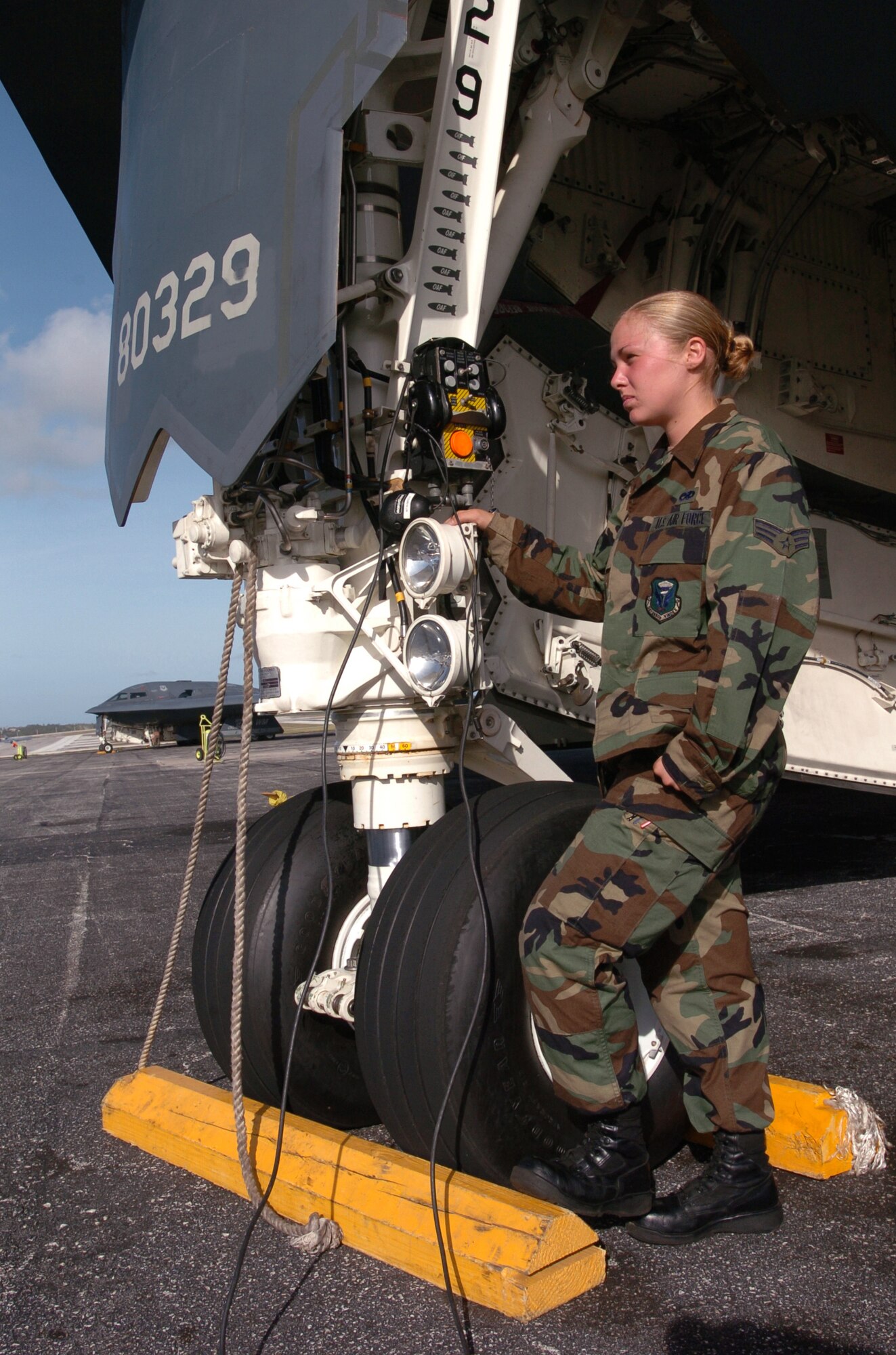 ANDERSEN AIR FORCE BASE, Guam -- Senior Airman Mindy High waits for an aircrew before a morning launch here.  B-2 Spirit bombers deployed here Feb. 25 to provide U.S. Pacific Command officials a continuous bomber presence in the Asia-Pacific region, enhancing regional security and the U.S. commitment to the Western Pacific.  Bomber aircraft have had an ongoing presence on the island since February 2004.  Airman High is a crew chief from the 509th Bomb Wing at Whiteman Air Force Base, Mo.  (U.S. Air Force photo by Master Sgt. Val Gempis)