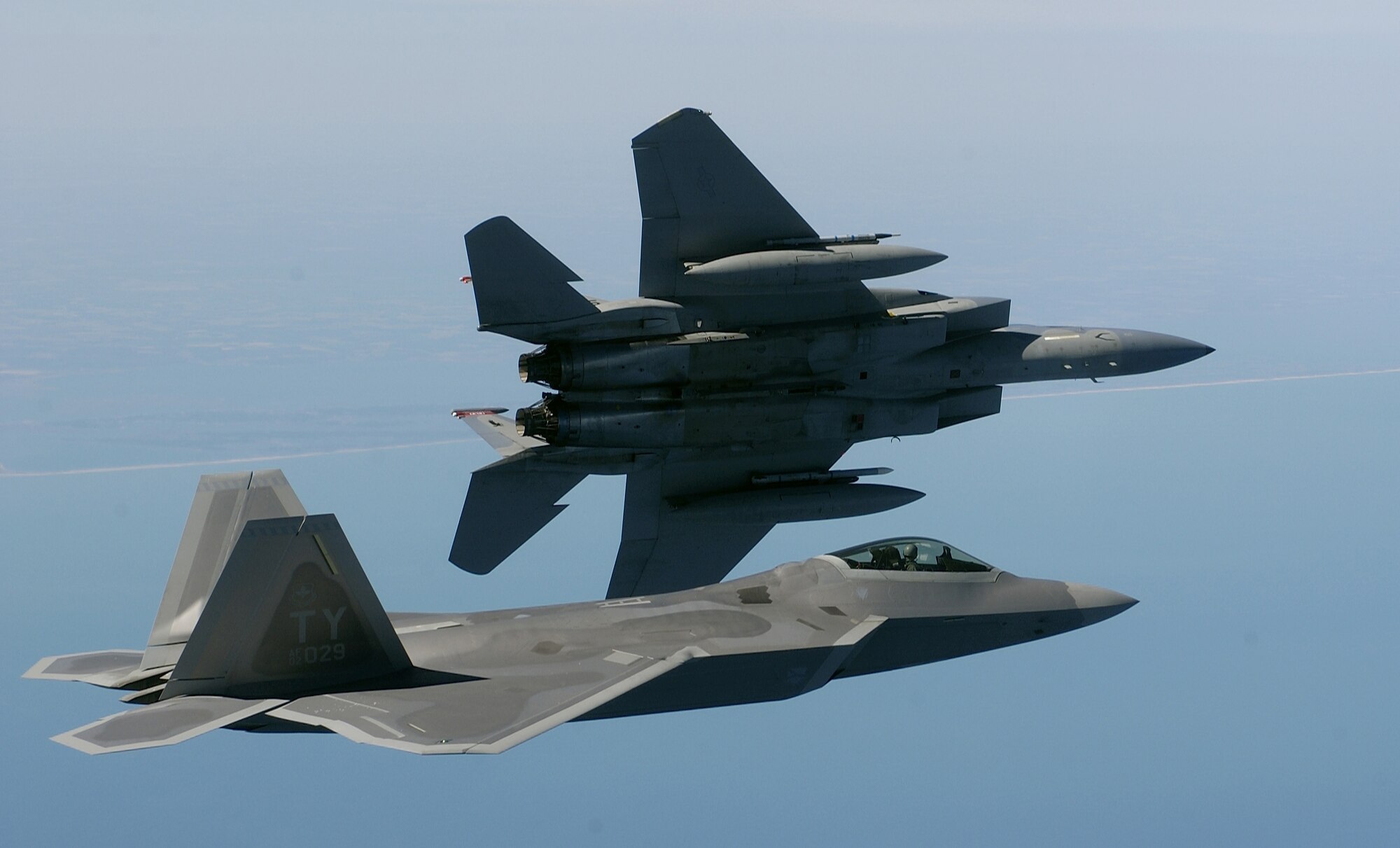 OVER THE ATLANTIC OCEAN -- An F-15 Eagle banks left while an F/A-22 Raptor flies in formation en route to a training area off the coastline of Virginia on April 5.  The 27th Fighter Squadron is performing regular operations with two Raptors on loan from Tyndall Air Force Base, Fla.  The first Langley AFB, Va., F-22 is due to arrive within the next month. The F-15 is assigned to the 1st Fighter Wing at Langley AFB. (U.S. Air Force photo by Tech. Sgt. Ben Bloker)
