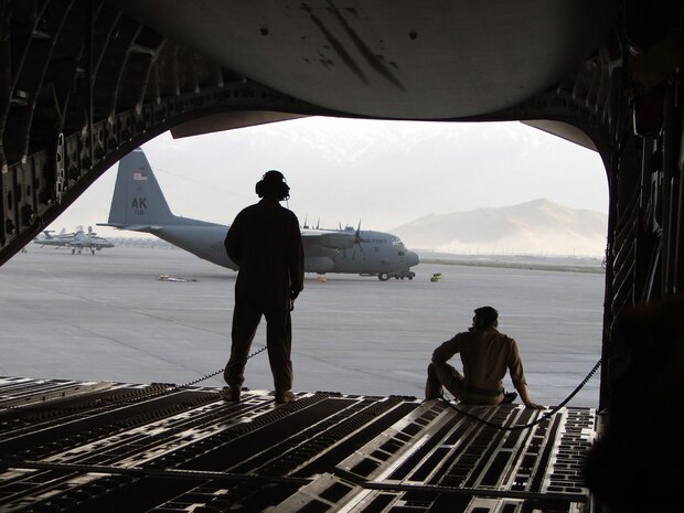 BARGRAM AIR BASE, Afganistan -- Senior Airmen Heath Burns, left, and Thomas Elsworth survey the airfield here after their C-17 Globemaster III taxis to a stop here April 4. They are C-17 loadmasters from Charleston Air Force Base, S.C. (U.S. Air Force photo by Tech. Sgt. Scott T. Sturkol)