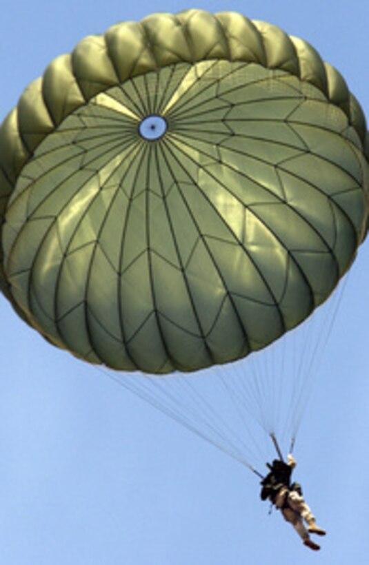 An Army paratrooper from the 82nd Airborne Division glides down to earth.