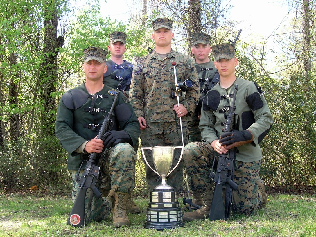 Security Forces Battalion Shooting Team poses with their Wirgman Small Unit Rifle Team Trophy which they were awarded, April 8, following the 2005 Eastern Division Matches. The team consists of Chief Warrant Officer 2 James Woodfin, Pfc. Benjamin Footer (from left, kneeling) and Pfc. Nicolas Friederich, Sgt. John Wellons and Pfc. Brandon Rokahr (standing).