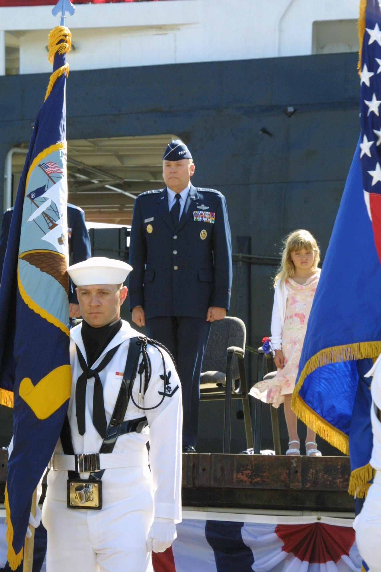 SUNNY POINT, N.C. -- Air Force Chief of Staff Gen. John P. Jumper stands with Brianna Chapman, 6, during the posting of the colors at the 
ship's renaming ceremony in honor of Brianna’s father, Tech. Sgt. John Chapman.  The ship was named for Sergeant Chapman, an Air Force combat controller who gave his life for his team in Afghanistan.  (U.S. Air Force photo by Senior Airman Becky J. LaRaia)