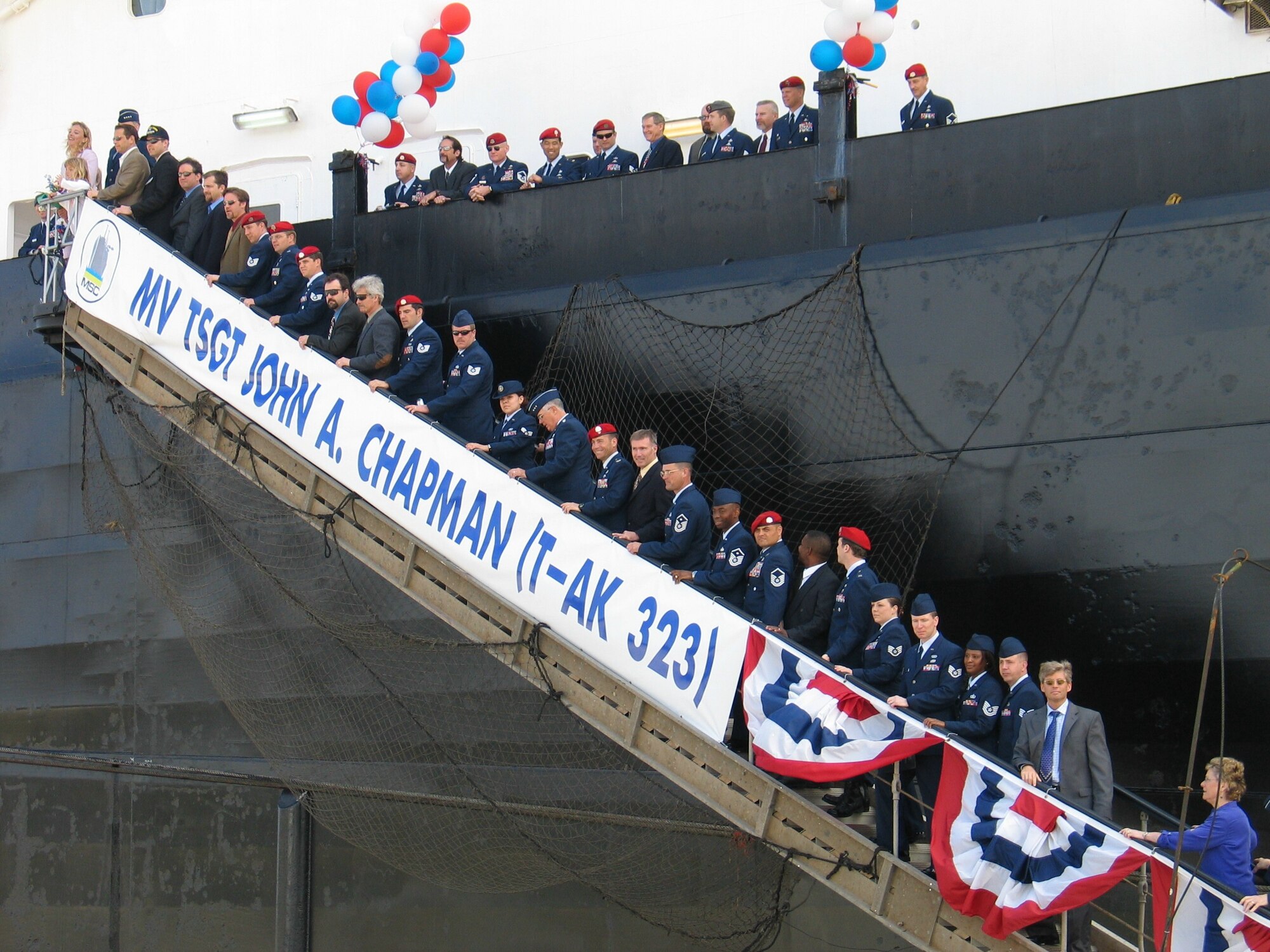 SUNNY POINT, N.C. -- Members of the special operations community join Gen. John P. Jumper, Valerie Chapman and her family on the gangplank of the MV Tech. Sgt. John A. Chapman here April 8 after the renaming of the ship. (U.S. Air Force photo by Michelle M. Butzgy)