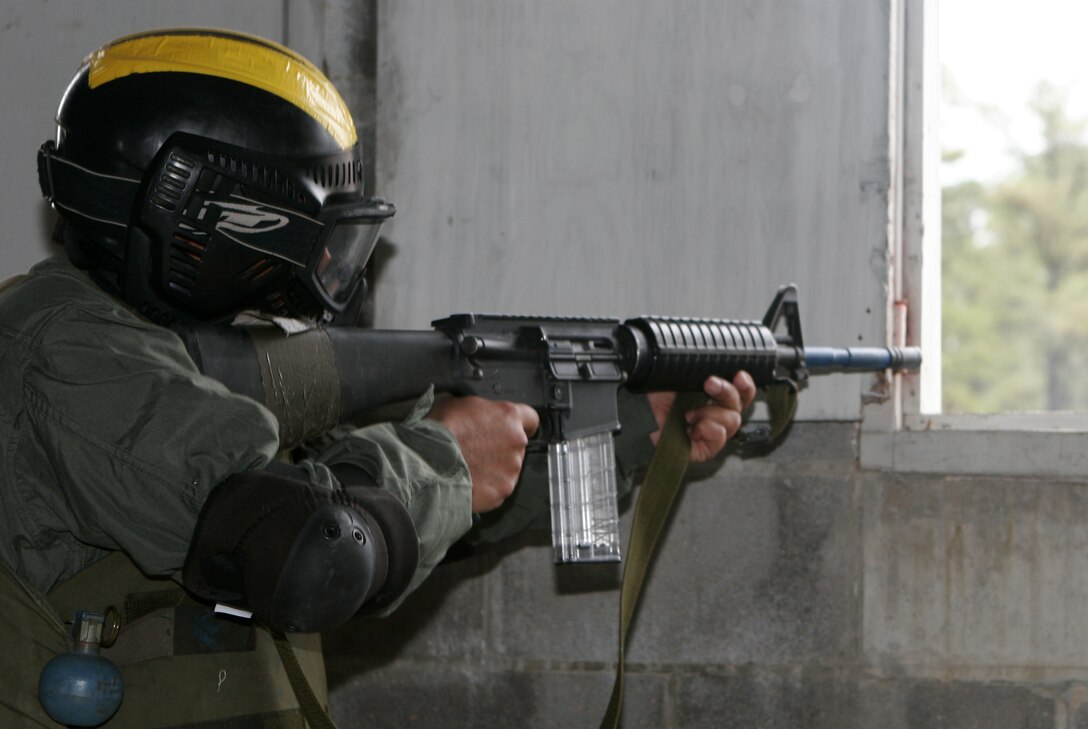 An officer with the Commando Kandak (battalion), Afghan National Army, takes aim during a simulated assault with Marines from 8th Communications Battalion. The ANA officers visited II Marine Expeditionary Force units to exchange ideas and tactics with the Marines.