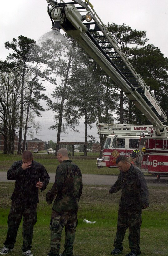 MARINE CORPS AIR STATION NEW RIVER, N.C. - Marines are decontaminated during the North Carolina Regional Exercise 2005 April 9 after coming under attack from a simulated chemical weapons attack.  The exercise was a chance for emergency services and base commanders to test and evaluate their responses to terrorist attacks. This exercise fulfills Department of Defense requirements for annual terrorist training and has been deemed a success by all involved, according to Col. Neil Hornung, deputy branch head of the critical infrastructure branch. (Official Marine Corps photo by Lance Cpl. Shane Suzuki)