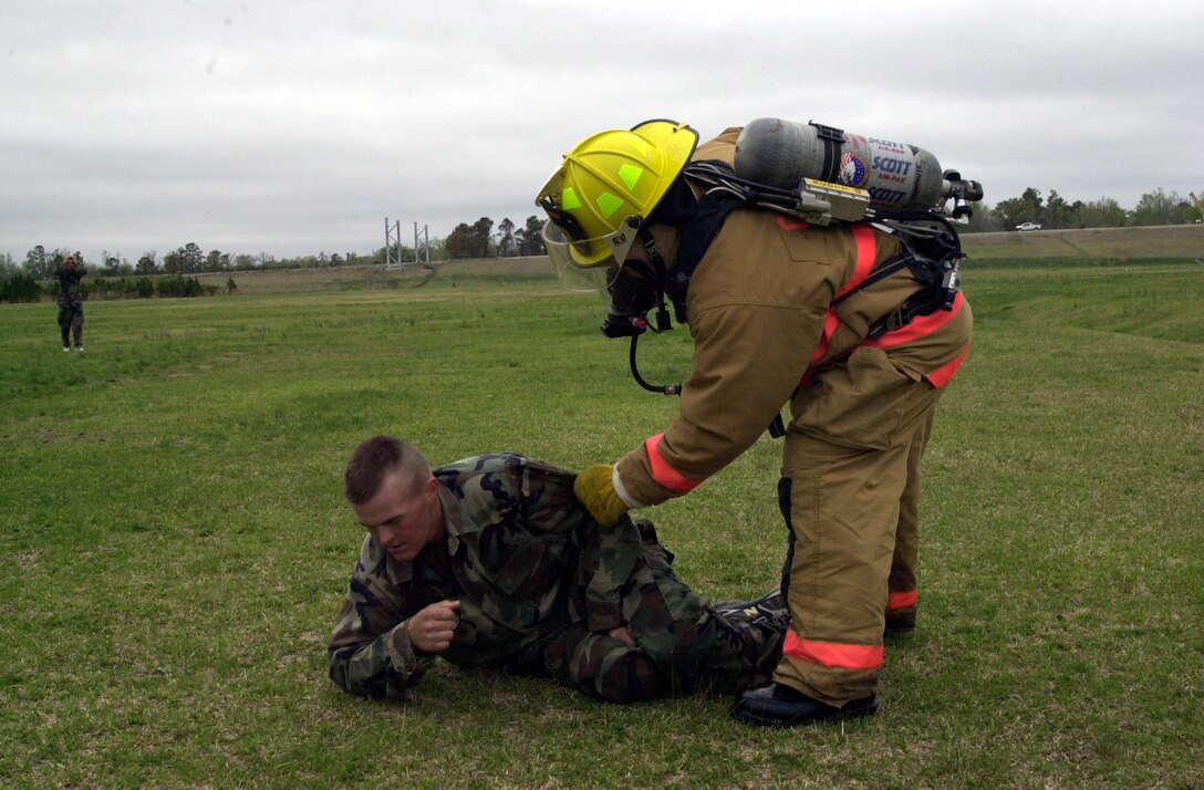 MARINE CORPS AIR STATION NEW RIVER, N.C. - A first responder helps a Marine during the North Carolina Regional Exercise 2005 April 9 after coming under attack from a simulated chemical weapons attack.  The exercise was a chance for emergency services and base commanders to test and evaluate their responses to terrorist attacks. This exercise fulfills Department of Defense requirements for annual terrorist training and has been deemed a success by all involved, according to Col. Neil Hornung, deputy branch head of the critical infrastructure branch. (Official Marine Corps photo by Lance Cpl. Shane Suzuki)