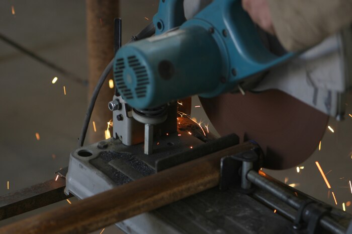 AL ASAD, Iraq – The four-Marine machinist and welding shop, Combat Logistics Battalion 2, 2d Force Service Support Group (Forward), creates, repairs and fabricates metal items to suit the needs of Marines throughout Western Iraq, including a cable trailer for which this support post is being cut. (Photo by Cpl. John E. Lawson Jr.)