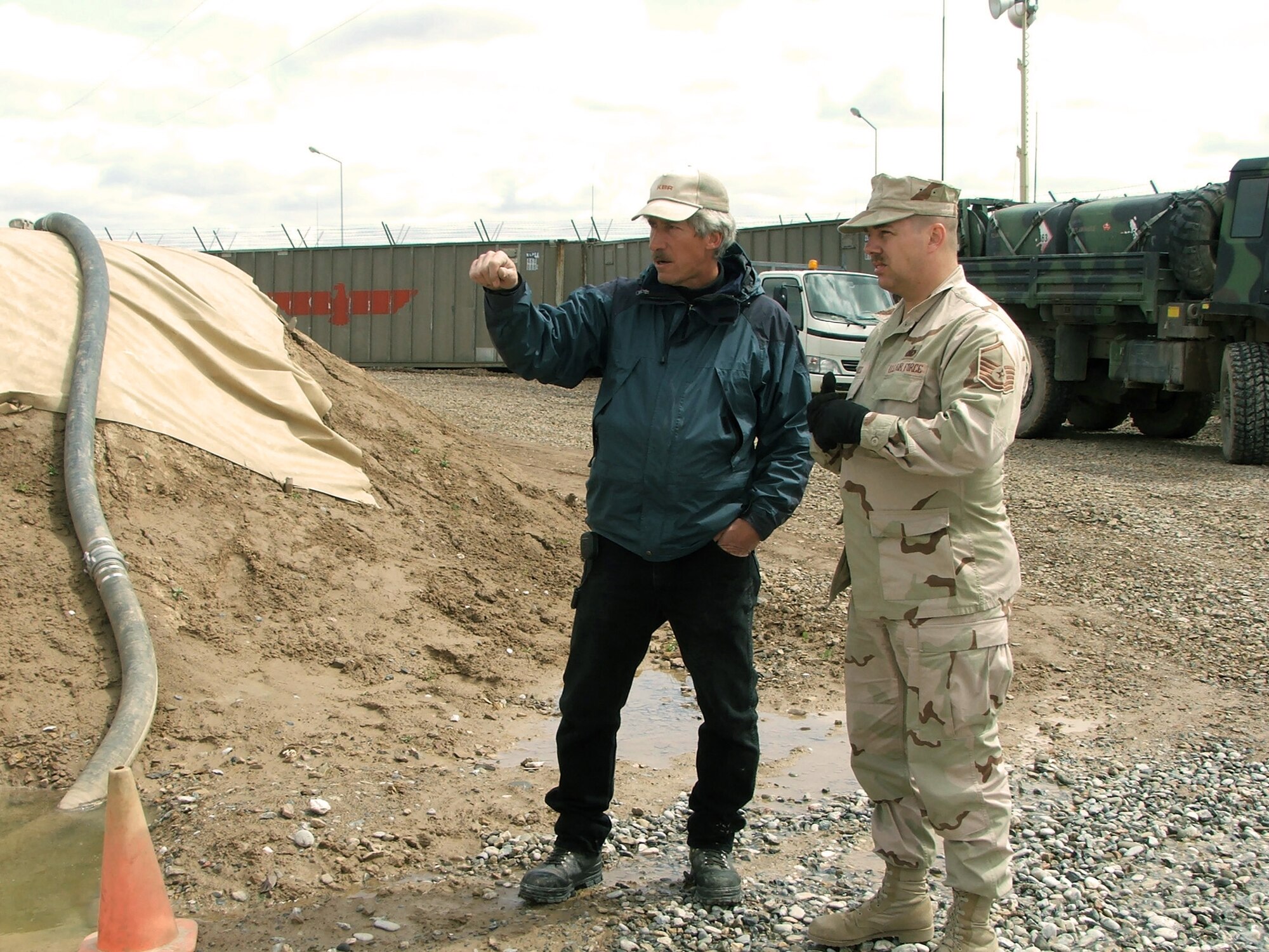 KARSHI-KHANABAD, Uzbekistan -- Master Sgt. Scott Ross discusses road improvements with Steven Bullock.  Mr. Bullock is the fuels foreman with the fueling contractor hired for base support, and Sergeant Ross is the 416th Expeditionary Mission Support Squadron's fuels management flight superintendent. (U.S. Air Force photo by Staff Sgt. Andrea Knudson)
