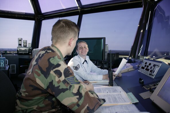 SHAW AIR FORCE BASE, S.C. - Staff Sgts. Garrick Christian (left) and Heather Beauchamp discuss flight patterns.  They are air traffic controllers with the 20th Operations Support Squadron.  (U.S. Air Force photo by Tarsha Storey)