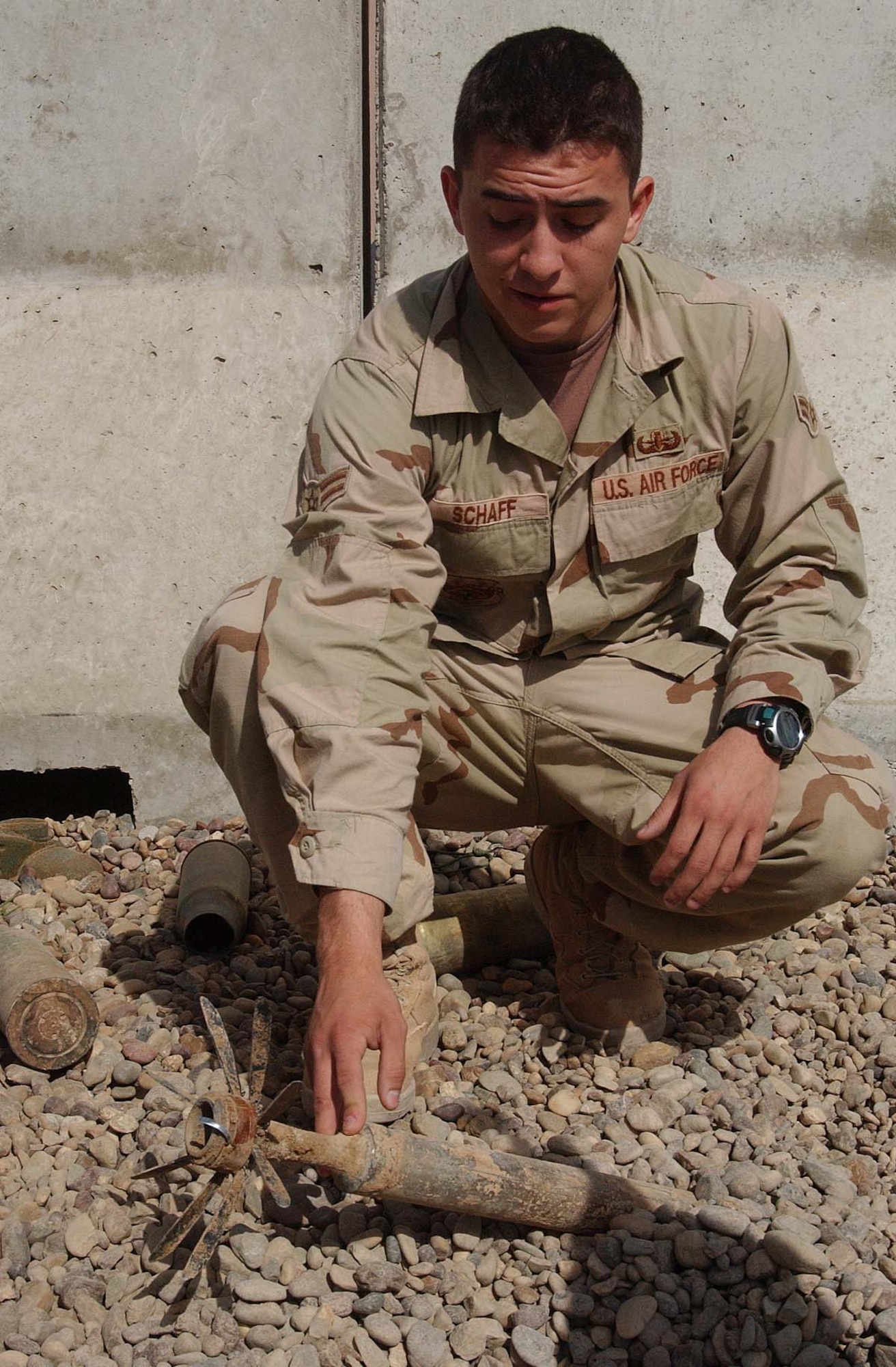 BALAD AIR BASE, Iraq -- Airman 1st Class Isaiah Schaff shows what common unexploded ordnance looks like.  He is a 332nd Expeditionary Civil Engineer Squadron explosive ordnance disposal technician here.  (U.S. Air Force photo by Senior Airman Colleen Wronek)
