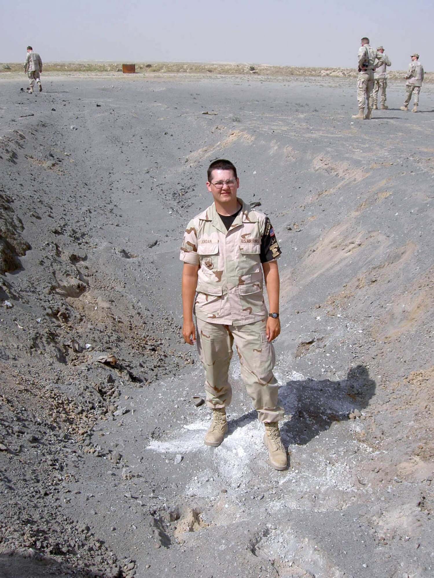 SOUTHWEST ASIA -- Airman 1st Class Juan Jordan stands in the spot where the Russian-made bomb he discovered was destroyed.  He found the bomb at a construction site at a forward-deployed location.  He credits his deployment training with helping him recognize the unexploded ordnance.  He is an avionics sensors maintenance apprentice deployed from the 9th Aircraft Maintenance Squadron at Beale Air Force Base, Calif.  (U.S. Air Force photo)