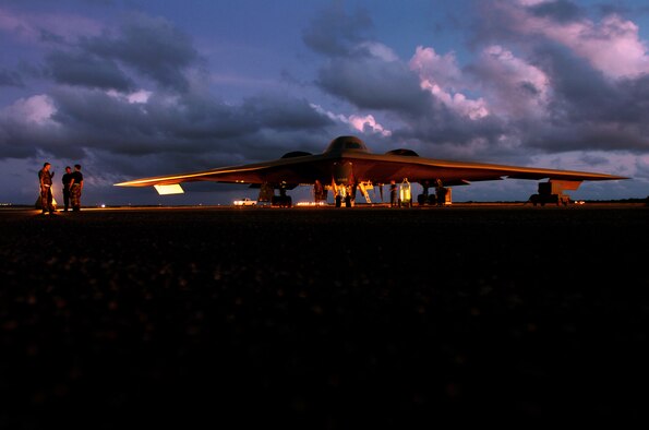 ANDERSEN AIR FORCE BASE, Guam -- Aircraft mechanics prepare a B-2 Spirit bomber before a morning mission here.  Bomber aircraft have had an ongoing presence on the island since February 2004.  The Airmen are deployed from the 509th Bomb Wing at Whiteman Air Force Base, Mo.  (U.S. Air Force photo by Master Sgt. Val Gempis)