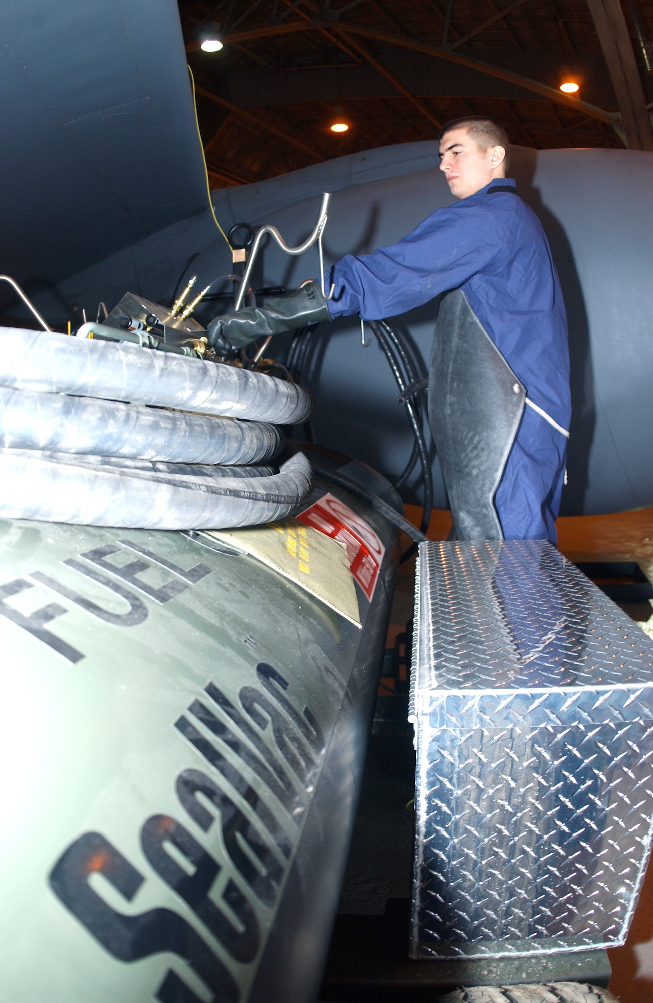 FAIRCHILD AIR FORCE BASE, Wash. -- Senior Airman Nicholas Hamstra applies vacuum pressure to drain fuel from a KC-135 Stratotanker.  The fuel bowser allows multiple tanks to be drained safer and quicker than the old draining method.  Airman Hamstra is a fuel systems journeyman with the 92nd Maintenance Squadron here.  (U.S. Air Force photo by Airman 1st Class Clay Lancaster)