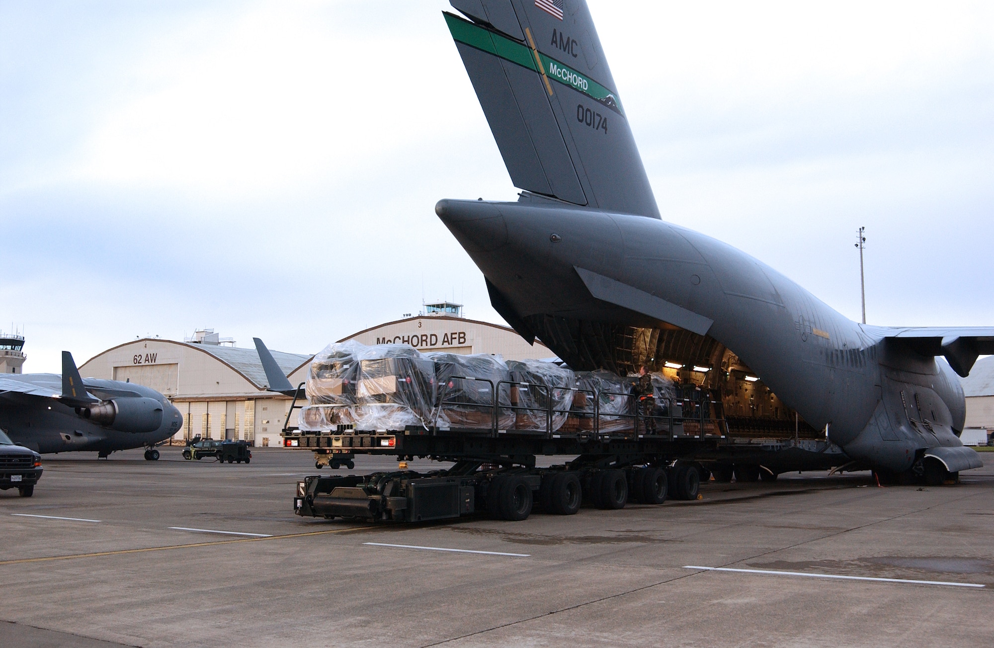 MCCHORD AIR FORCE BASE, Wash. -- Pallets of fuel are loaded onto a C-17 Globemaster III here to support the C-17 Globemaster III's first polar airdrop.  About 10,000 gallons of fuel were dropped to help National Science Foundation scientists near the North Pole.  (U.S. Air Force photo by Kevin J. Tosh Jr.)