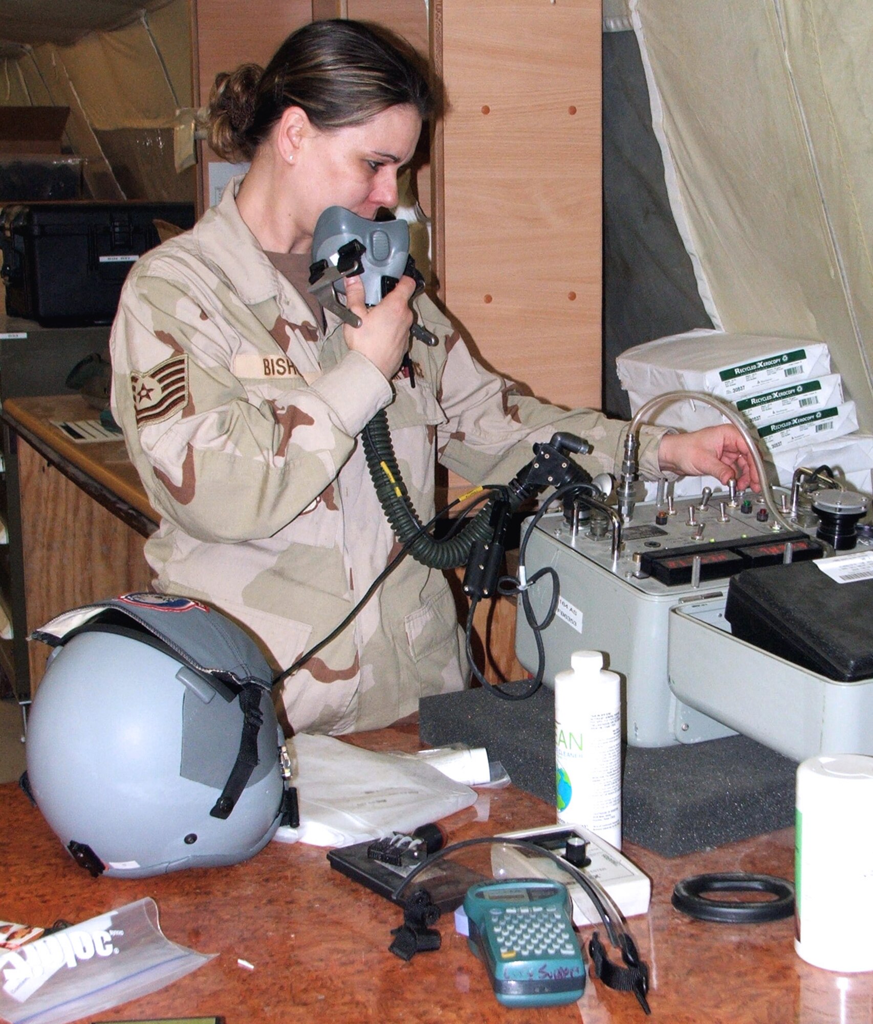 KARSHI-KHANABAD, Uzbekistan -- Tech. Sgt. Heidi Bishop inspects helmets and masks for aircrews deployed here.  She is assigned to the 774th Expeditionary Airlift Squadron life-support section and is deployed from Mansfield, Ohio.  (U.S. Air Force photo by Staff Sgt. Andrea Knudson)
