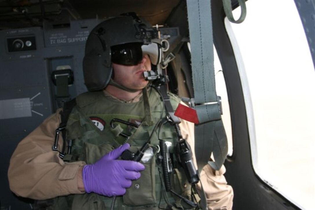 AL ASAD, Iraq - Sgt. Christopher Orange, flight medic, 571st Medical Company (Air Ambulance) watches the left side of his UH-60A Blackhawk enroute to another medical evacuation April 14.