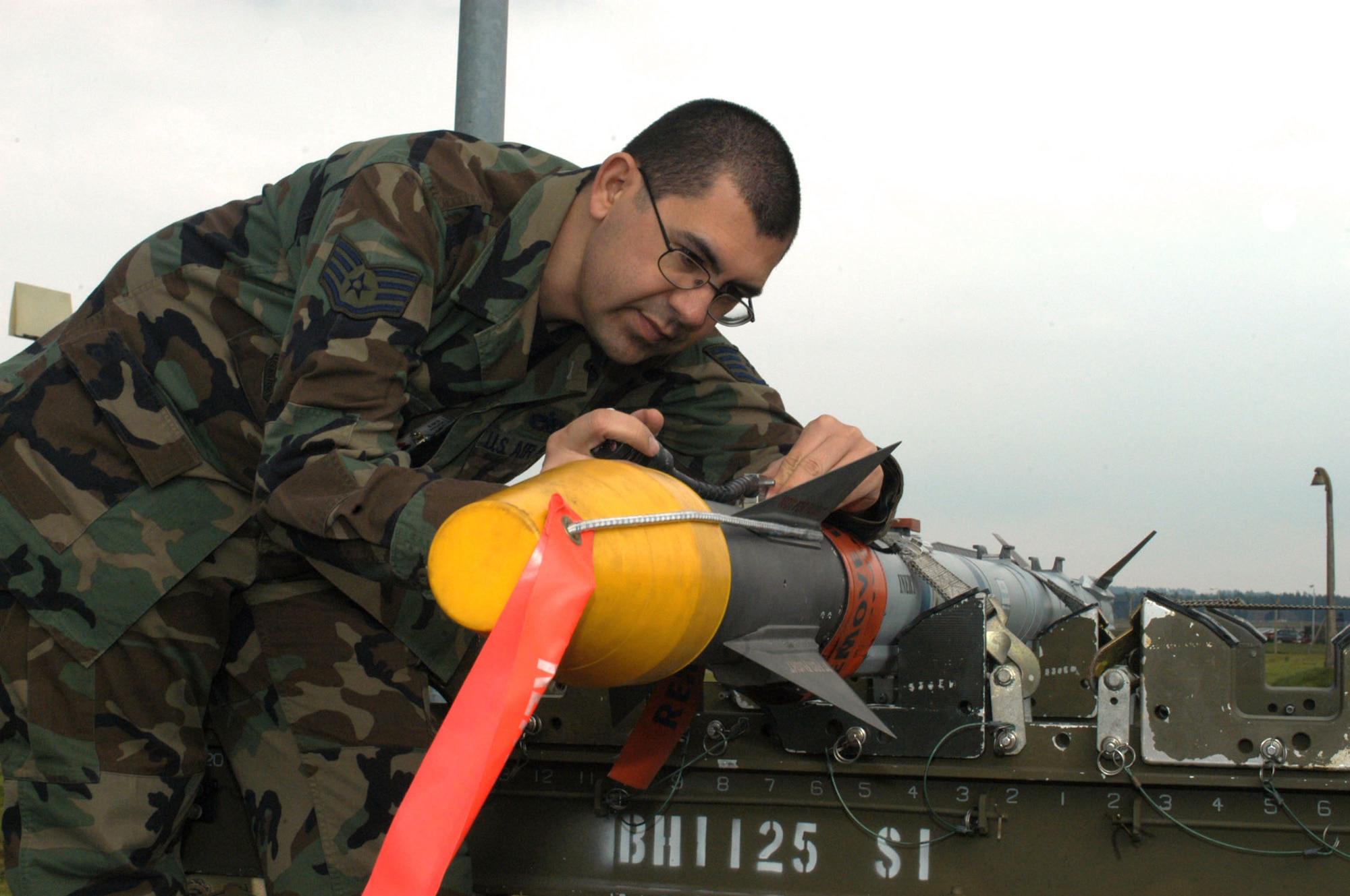 ROYAL AIR FORCE LAKENHEATH, England -- Staff Sgt. Antonio Guerrero inspects the umbilical cable and block connection on an Air Intercept Missile-9X.  Sergeant Guerrero was one of two people who received the first Air Intercept Missile-9X Cutting Edge Award.  He is assigned to the 48th Munitions Squadron here.  (U.S. Air Force photo by Verla Davis)