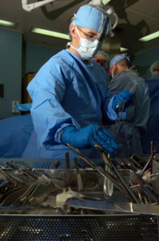 U.S. Navy Hospitalman Josh Scott organizes surgical tools during an operation on an Indonesian woman aboard the hospital ship USNS Mercy (T-AH 19) on April 12, 2005. Mercy and the combat stores ship USNS Niagara Falls (T-AFS 3) are currently operating off the coast of Nias, providing medical and humanitarian assistance to victims of the March 28, 2005, 8.7-magnitude earthquake. 