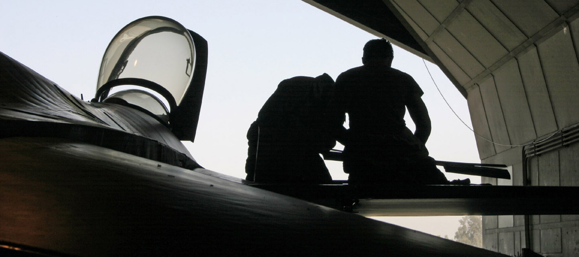 BALAD AIR BASE, Iraq -- Senior Airman Shawn Justus (left) and Airman 1st Class Colin Muller prepare for an 800-hour maintenance procedure and inspection on an F-16 Fighting Falcon.  They are crew chiefs with the 332nd Expeditionary Aircraft Maintenance Squadron here.  (U.S. Air Force photo by Staff Sgt. Adam Bradford)