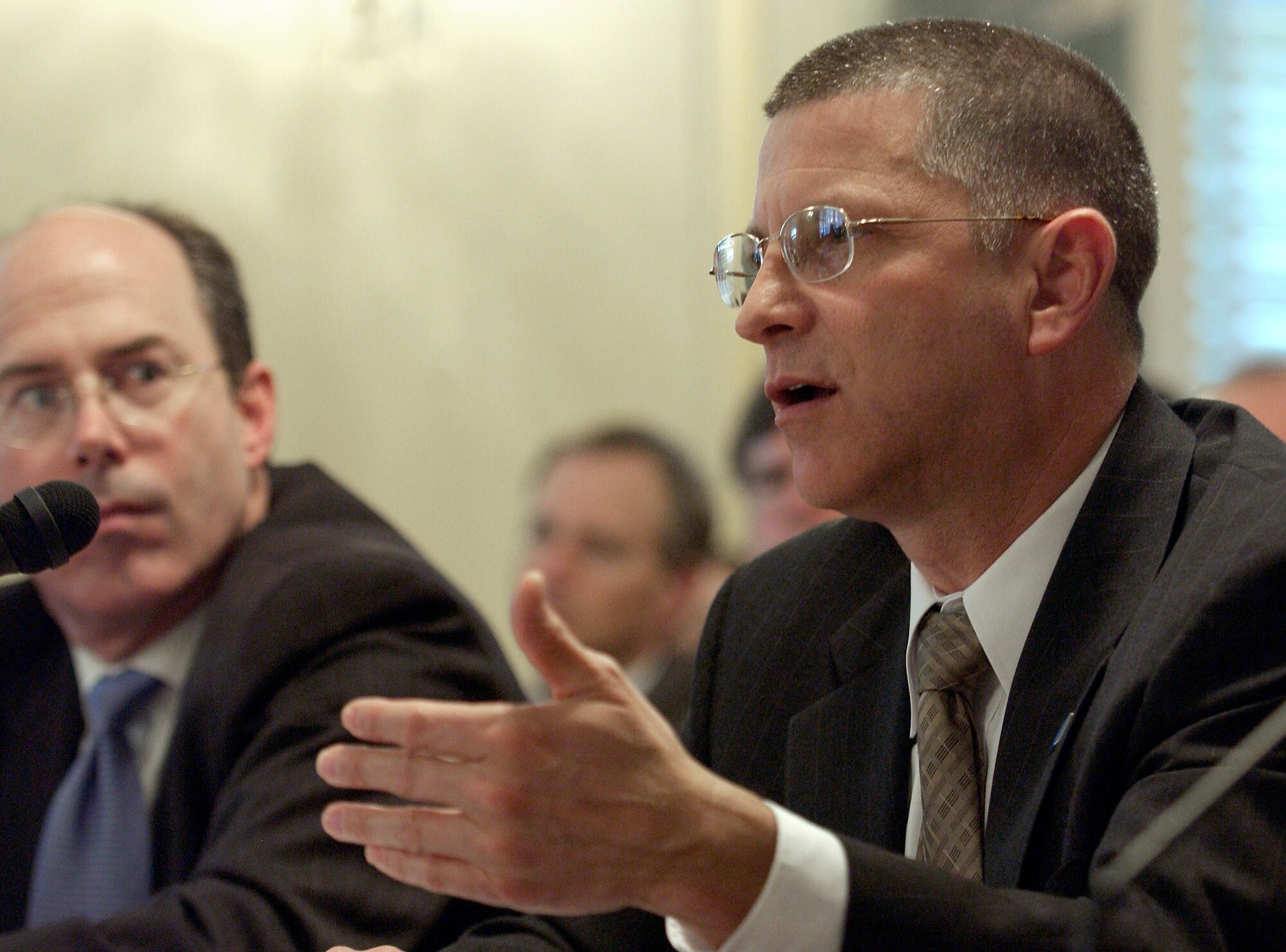 WASHINGTON -- Department of Defense Inspector General Joseph Schmitz (left) looks on as Michael L. Dominguez, acting secretary of the Air Force, answers questions during a hearing of the Senate Armed Services Committee subcommitee on airland April 14.  The subcommittee heard testimony on Air Force acquisition oversight.  (U.S. Air Force photo by Master Sgt. Jim Varhegyi)