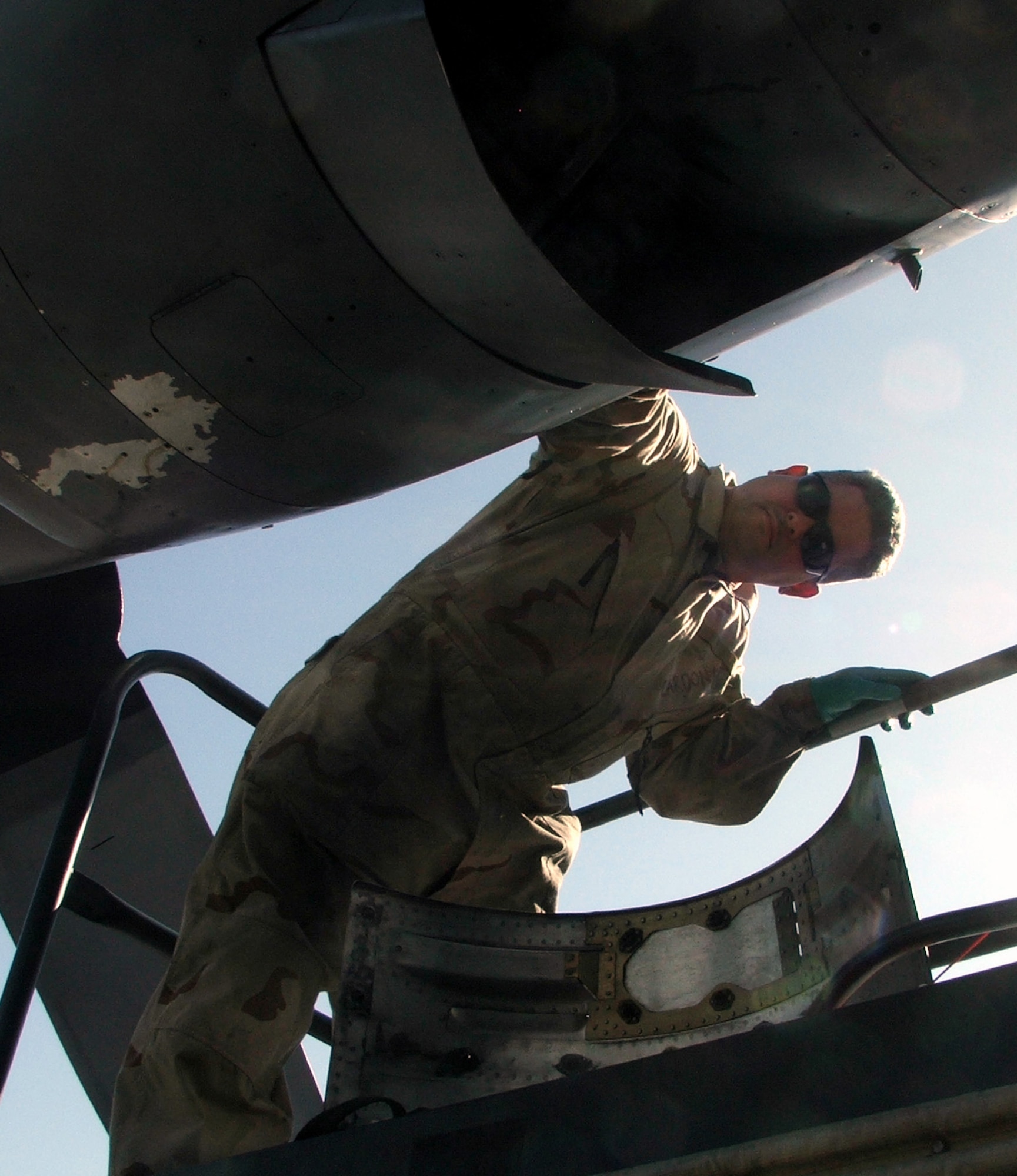 KARSHI-KHANABAD AIR BASE, Uzbekistan -- Tech. Sgt. Noel Cardona reassembles a C-130 Hercules engine compartment here April 14.  He is a C-130 engine mechanic with the 774th Expeditionary Airlift Squadron and is deployed from the Ohio Air National Guard at Mansfield.  (U.S. Air Force photo by Tech. Sgt. Scott T. Sturkol)