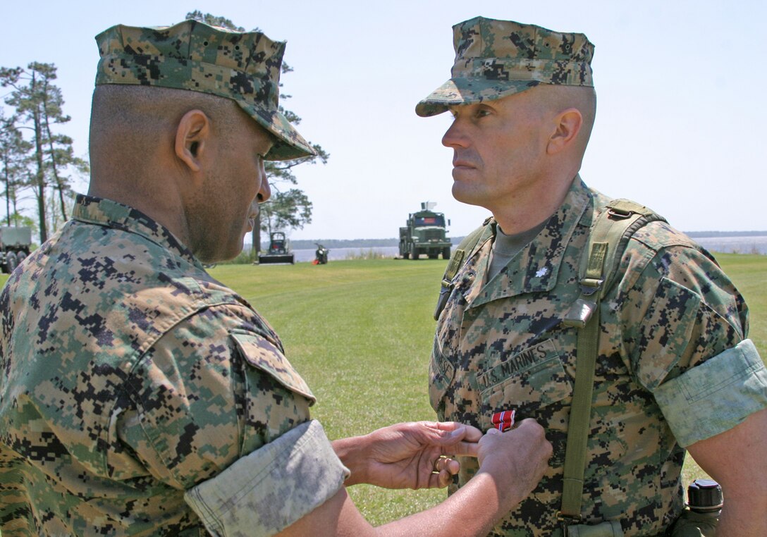LtCol. Vincent A. Coglianese, Marine Expeditionary Unit Service Support Group-24 Commanding Officer, receives a Bronze Star Medal during the MSSG-24 change of command ceremony at Camp Lejeune, N.C., from 2nd Force Service Support Group Commanding General, Brig. Gen. Ronald S. Coleman, for his actions while serving in Iraq during Operation Iraqi Freedom II.