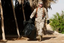 Staff Sgt. Alfred Hickman and Sgt. Sandro Kitzmann work on a computer outside in Camp Falluhah, Iraq.  Software that Marines now use on their government computers cost the government much less because of successful efforts by the Marine Corps Software Enterprise License Management System.