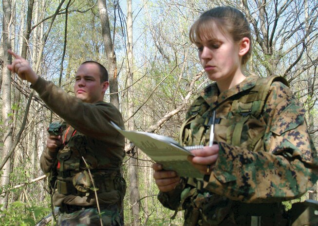 Eric R. Steward, 25, of Indianapolis (left), points a path as Brigitte L. McMillan, 20, of Marion, Ind. (right), studies her pace count in her notes during the land navigation course at Camp Atterbury, Ind.  The course gives candidates an opportunity to steer their way through Camp Atterbury's hilly, wooded terrain.