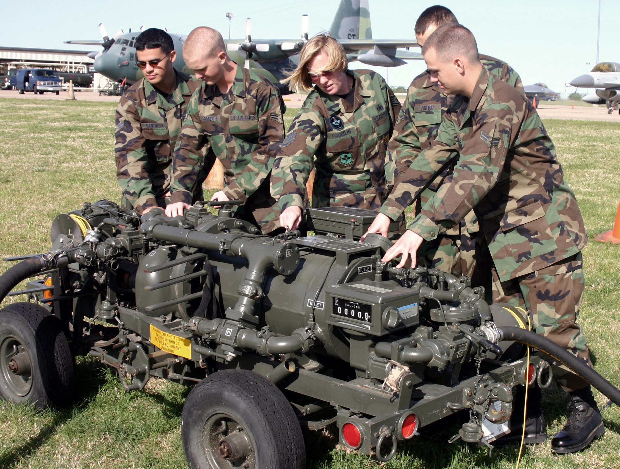 SHEPPARD AIR FORCE BASE, Texas -- Staff Sgt. Kathleen Franklin discusses the pump used for a mobile gas station with students in the fuels apprentice course here.  Airmen attending the course are now required to complete a seven-day contingency course, getting them two to three months closer to combat-ready status after arriving at their first base.  Sergeant Franklin is an instructor with the 366th Training Squadron.  (U.S. Air Force photo by John Ingle)