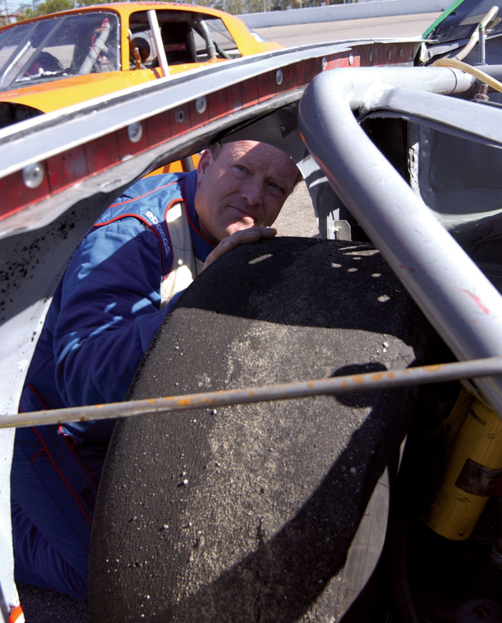 KENLY, N.C. -- Master Sgt. Warren Howard checks his tire's clearance before a race here recently.  If there is not enough space between the tire and frame, it can cause an accident during the race.  He has raced cars since he was 16 years old and is the environmental coordinator with the 4th Equipment Maintenance Squadron.  (U.S. Air Force photo by Airman Frank Snider)
