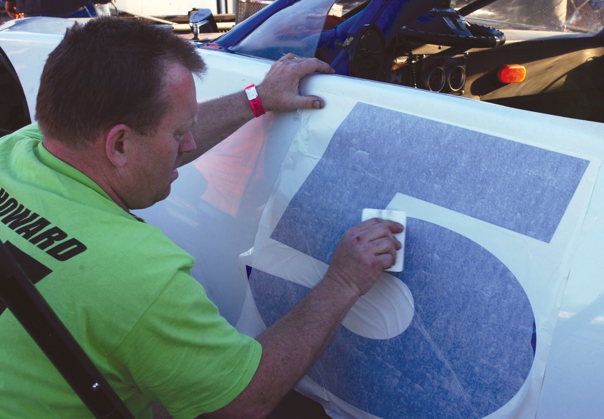 KENLY, N.C. -- Master Sgt. Warren Howard applies a number to one of his teammate's cars here.  He has raced cars since he was 16 years old and is the environmental coordinator with the 4th Equipment Maintenance Squadron.  (U.S. Air Force photo by Airman Frank Snider)