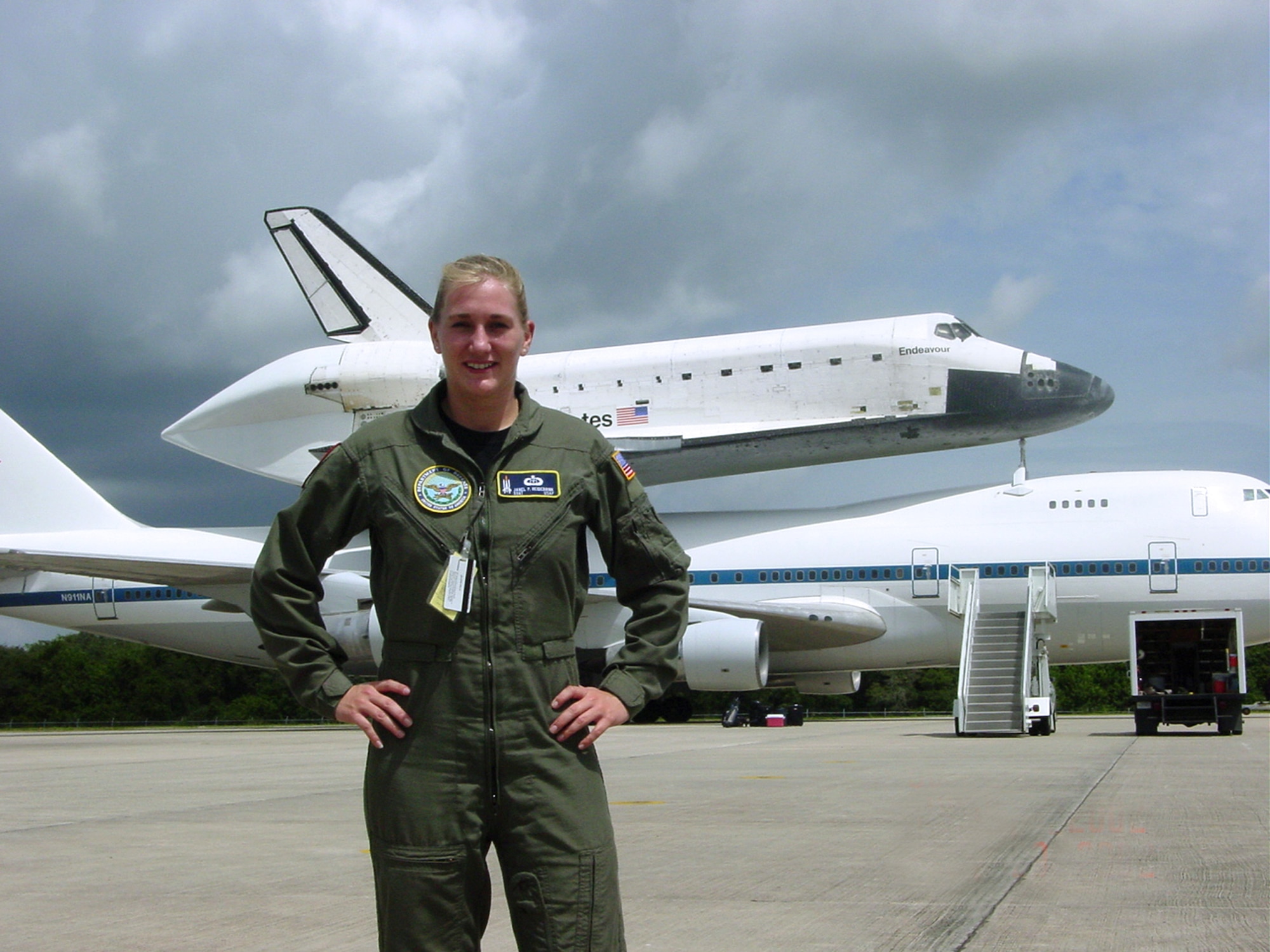 EDWARDS AIR FORCE BASE, Calif. -- Tech. Sgt. Janel Uiterwyk stands in front of Space Shuttle Endeavour which is mounted on a modified Boeing 747 here.  The 747 is used to ferry the shuttle to its original landing site if forced to land in another location.  Sergeant Uiterwyk is assigned to the 45th Weather Squadron at Patrick Air Force Base, Fla.  (U.S. Air Force photo by 1st Lt. Michael Jennings)