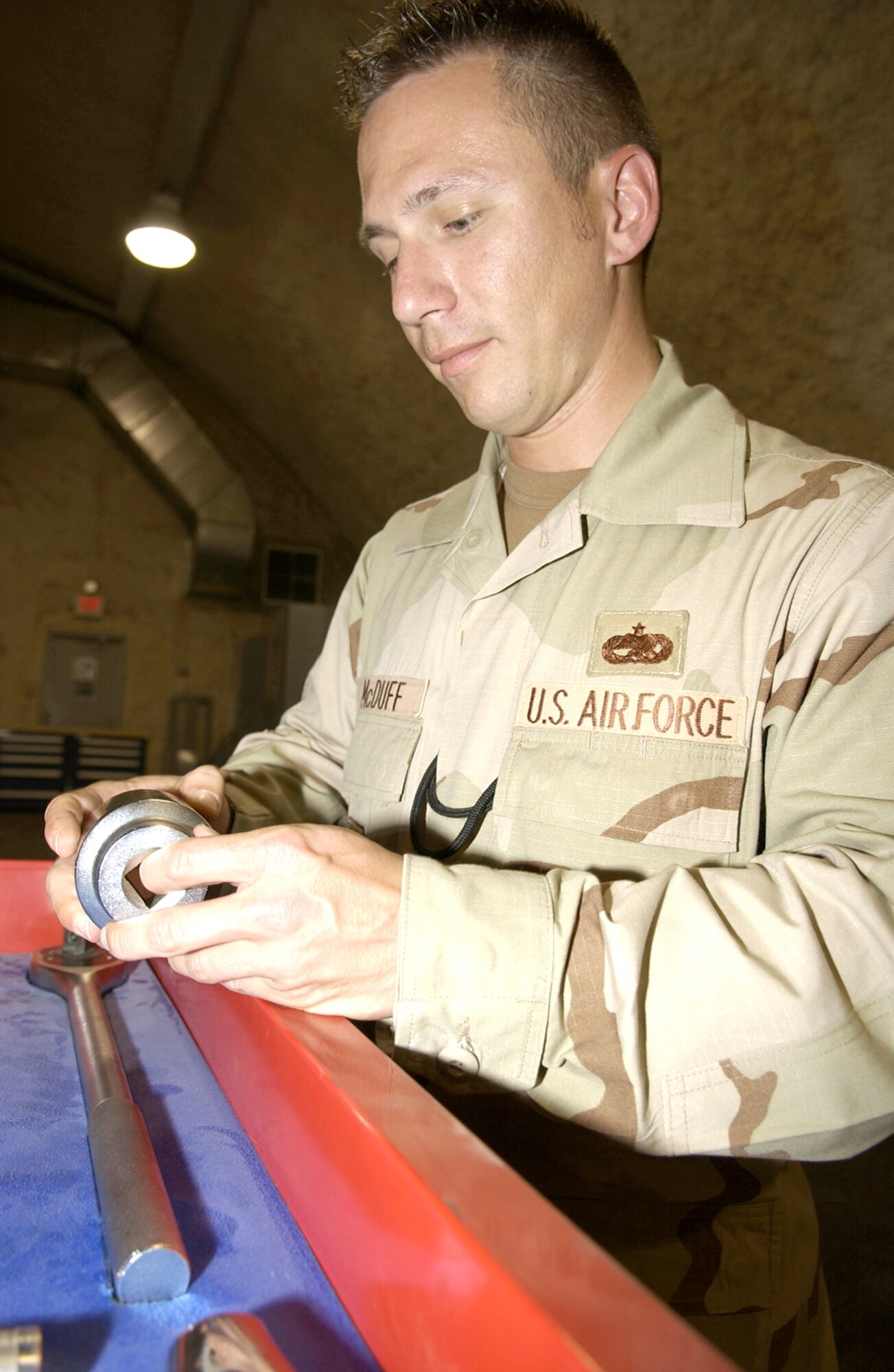 SOUTHWEST ASIA -- Tech. Sgt. Shawn McDuff inspects a composite tool kit for erosion and damage at a forward-deployed location April 12.  He is the 379th Expeditionary Maintenance Group quality assurance chief inspector and is deployed from Tinker Air Force Base, Okla.  (U.S. Air Force photo by Senior Master Sgt. John Snow)