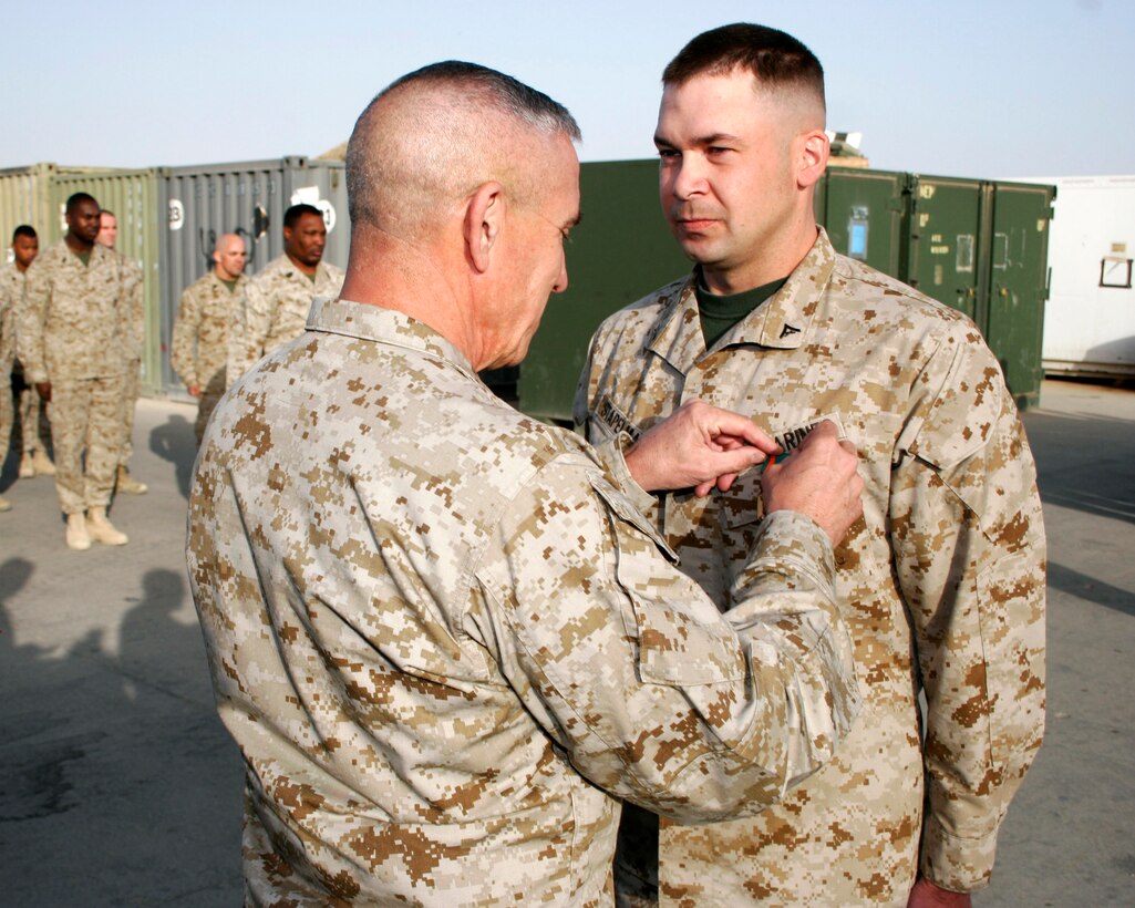 AL ASAD, Iraq ? Lieutenant Gen. Martin R. Berndt, U.S. Marine Corps Forces, Atlantic commander, pins a Navy and Marine Corps Achievement Medal on Lance Cpl. Wesley M. Stapelman, a data systems technician assigned to the Aviation Information Systems Department of Marine Aviation Logistics Squadron 26 (Reinforced).  Stapelman, a Great Falls, Mont., native, is reinforcing MALS-26 out of MALS-13 from Marine Corps Air Station, Yuma, Ariz.