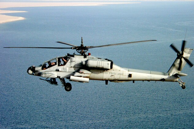 KALSU, Iraq ? An AH-64A Apache from Task Force 1/151st Aviation Attack Battalion, a U.S. Army unit supporting the 2nd Marine Aircraft Wing (Forward) here, flies over the Euphrates River on April 21.  The Apaches in the task force were painted gray before the unit deployed here and are the only gray aircraft in the entire U.S. Army inventory.