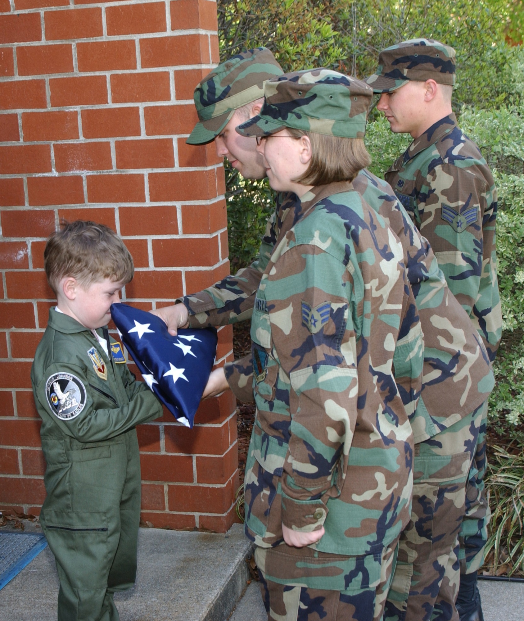 SEYMOUR JOHNSON AIR FORCE BASE, N.C. -- At the end of a memorable day, Evan Moriarty participates in a retreat ceremony with the help of students at the Airman leadership school April 15.  After the ceremony, Evan was given the flag that flew over the school that day.  (U.S. Air Force photo by Airman 1st Class Micky Bazaldua)