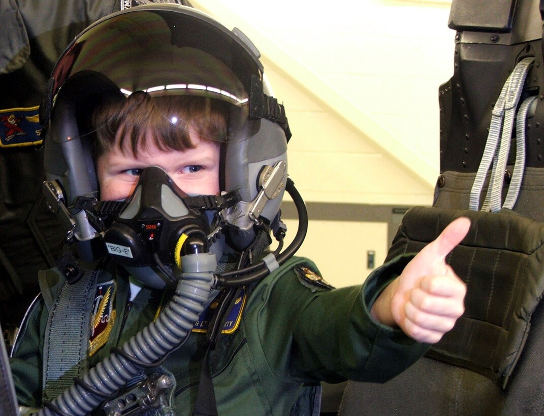 SEYMOUR JOHNSON AIR FORCE BASE, N.C. -- Five-year-old Evan Moriarty gives a thumbs up to family and friends during a ride in an F-15E Strike Eagle simulator April 15.  Riding in a jet has been a long time wish of the "Top Gun" fan, which was made possible by the Make-a-Wish Foundation and Airmen here.  (U.S. Air Force photo by Airman 1st Class Pablo Jara Meza)