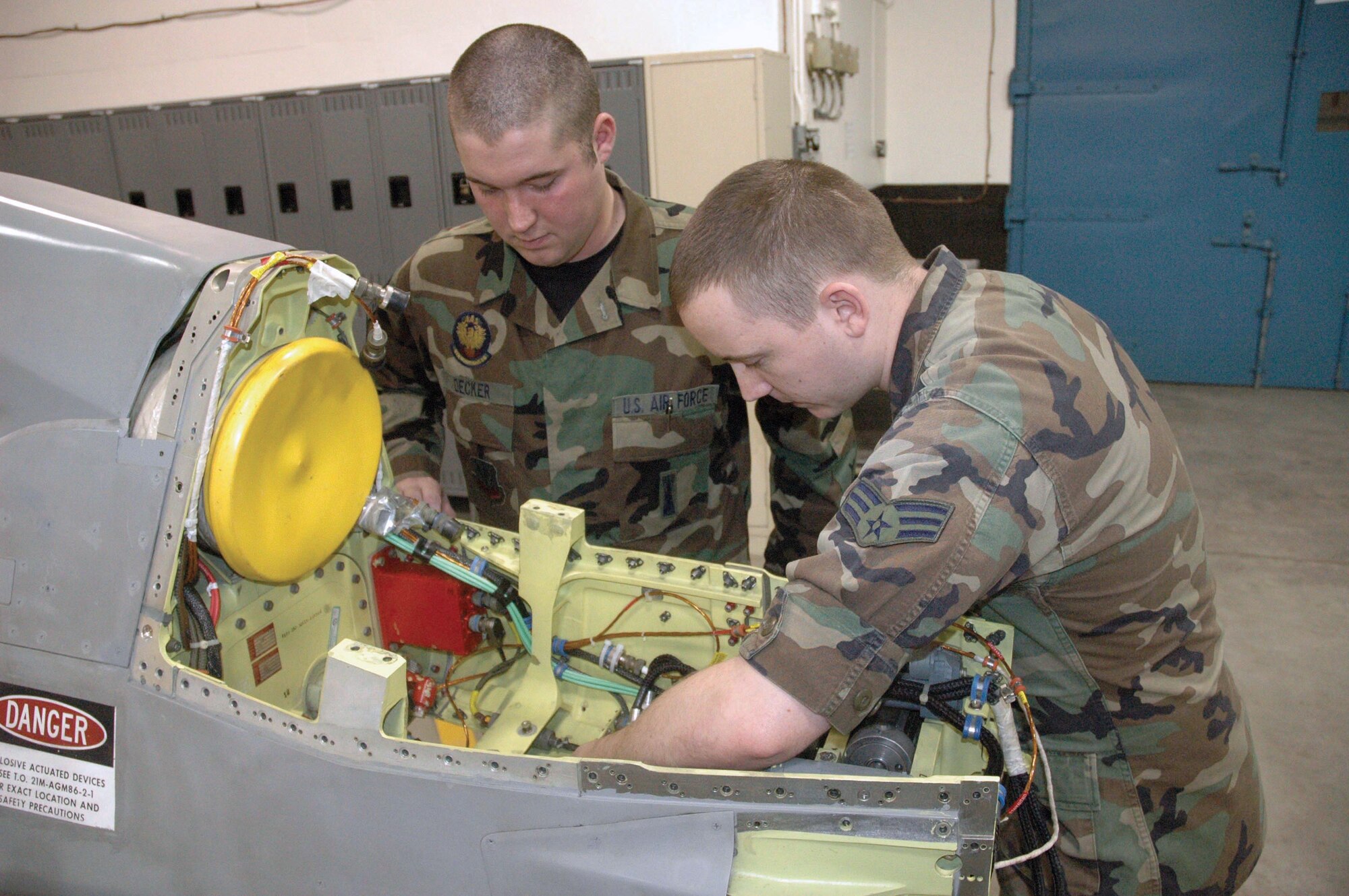MINOT AIR FORCE BASE, N.D. -- Senior Airmen Justin Decker (left) and Shiloh Feigley examine an air-to-ground missile in the weapons storage area here.  The B-52 Stratofortress can hold up to 20 of these missiles.  The Airmen are missile and space systems electronic maintainers with the 5th Munitions Squadron.  (U.S. Air Force photo by Airman 1st Class Ross Tweten)