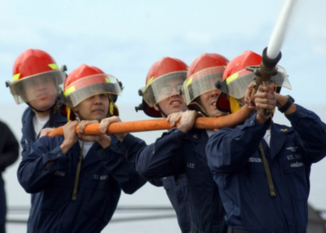 Sailors assigned to a repair locker fire party participate in a hose-handling event during the Damage Control Olympics held on board the aircraft carrier USS Harry S. Truman (CVN 75) on April 12, 2005. Each of Truman's repair lockers participated in several events to determine which repair locker was the best aboard the ship. The Truman Carrier Strike Group is currently returning from a four-month deployment to the Persian Gulf. 