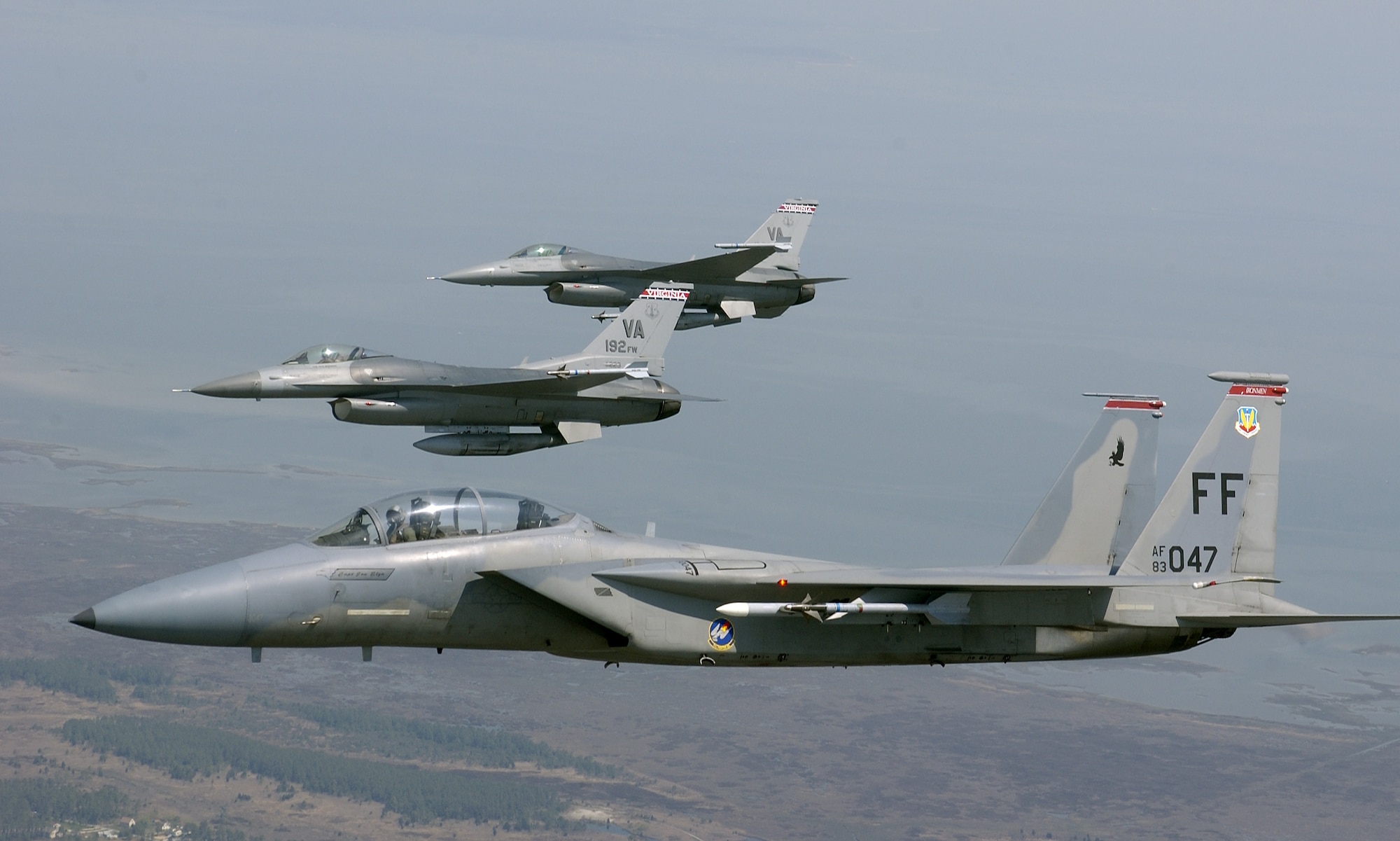 OVER VIRGINIA -- An F-15 Eagle is joined in formation by  F-16 Fighting Falcons during a training sortie here April 19. The F-15 is assigned to the 71st Fighter Squadron at Langley Air Force Base, Va., and the F-16s are assigned to the Virginia Air National Guard's 192nd Fighter Wing in Richmond.   (U.S. Air Force photo by Tech. Sgt. Ben Bloker)