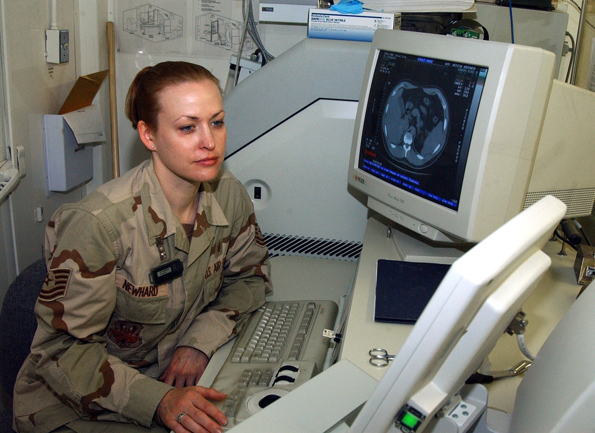BALAD AIR BASE, Iraq -- Tech. Sgt. BJ Newhard plots an exam for a CT scan here.  She is noncommissioned officer in charge of the 332nd Expeditionary Medical Support Squadron's radiology flight and is deployed from Lackland Air Force Base, Texas.  (U.S. Air Force photo by Senior Airman Colleen Wronek)       